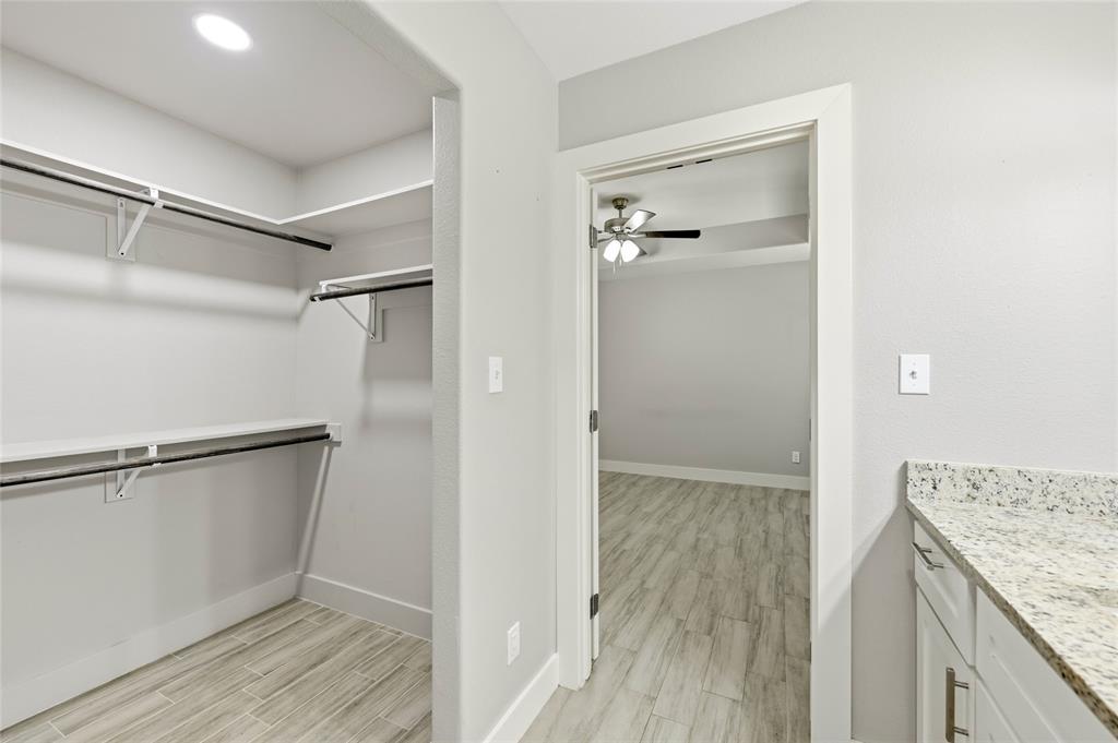 318 Munson Street Denison, TX 75021 - Photo 13 of 21 a view of walk in closet with empty racks