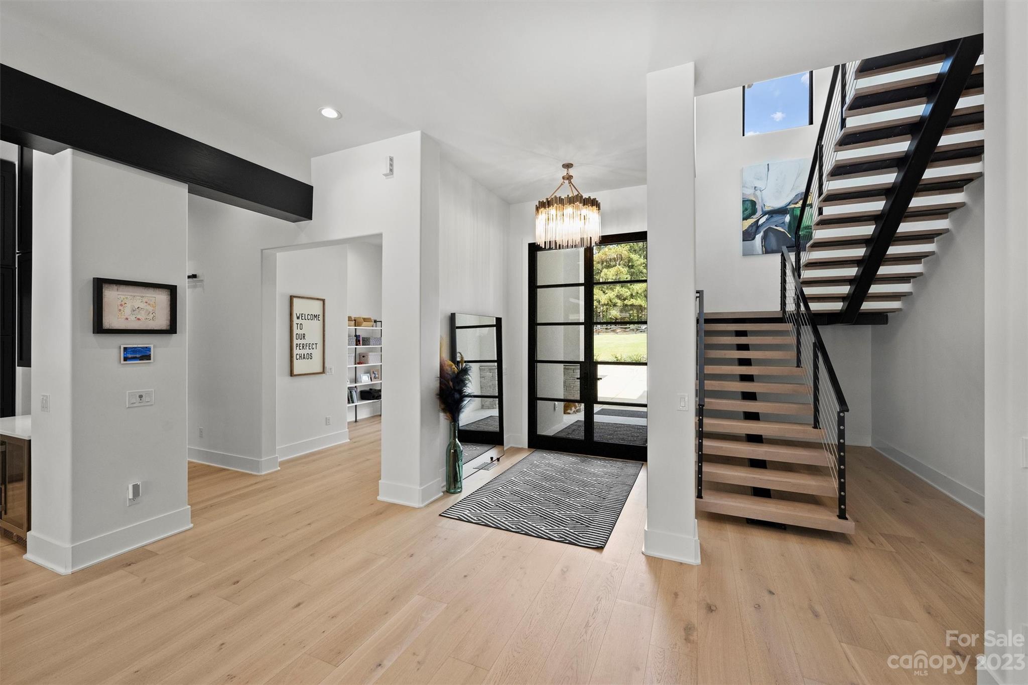 20108 Schooner Drive Cornelius, NC 28031 - Photo 11 of 46 wooden floor in an empty room with windows and entryway