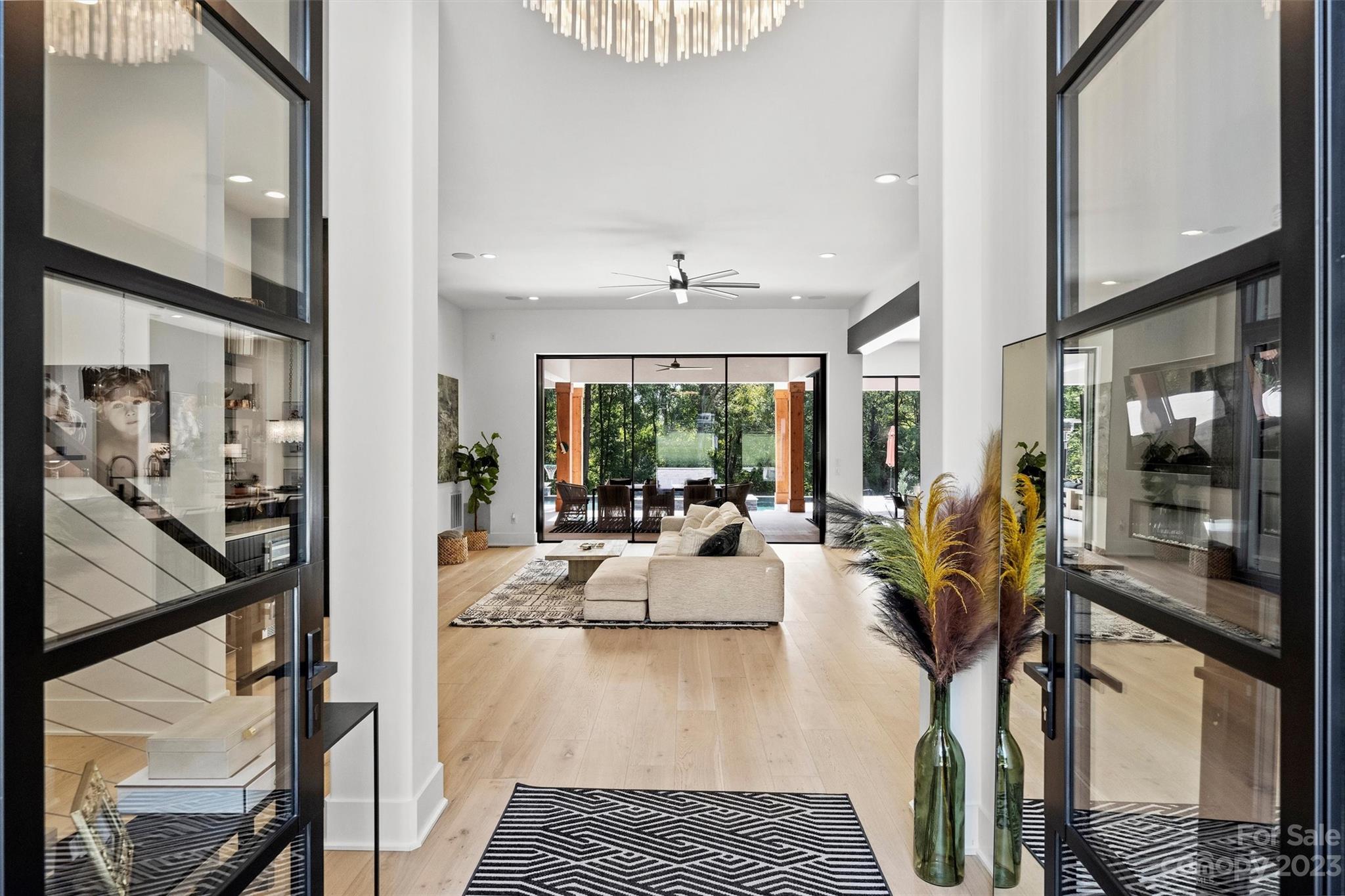 20108 Schooner Drive Cornelius, NC 28031 - Photo 14 of 46 a view of a living room and kitchen floor to ceiling windows