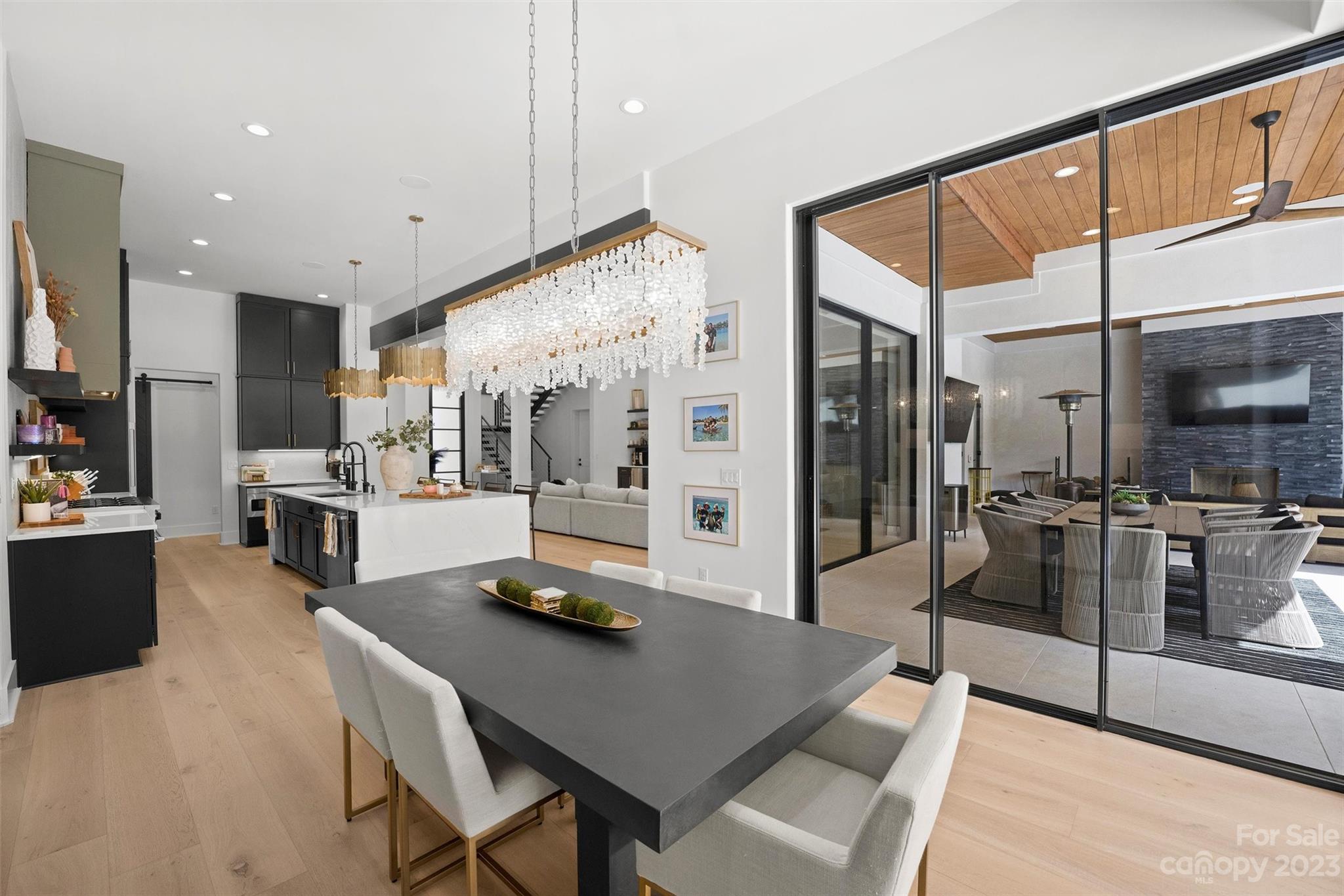 20108 Schooner Drive Cornelius, NC 28031 - Photo 16 of 46 a kitchen with stainless steel appliances kitchen island granite countertop a refrigerator a stove and a sink with wooden floor