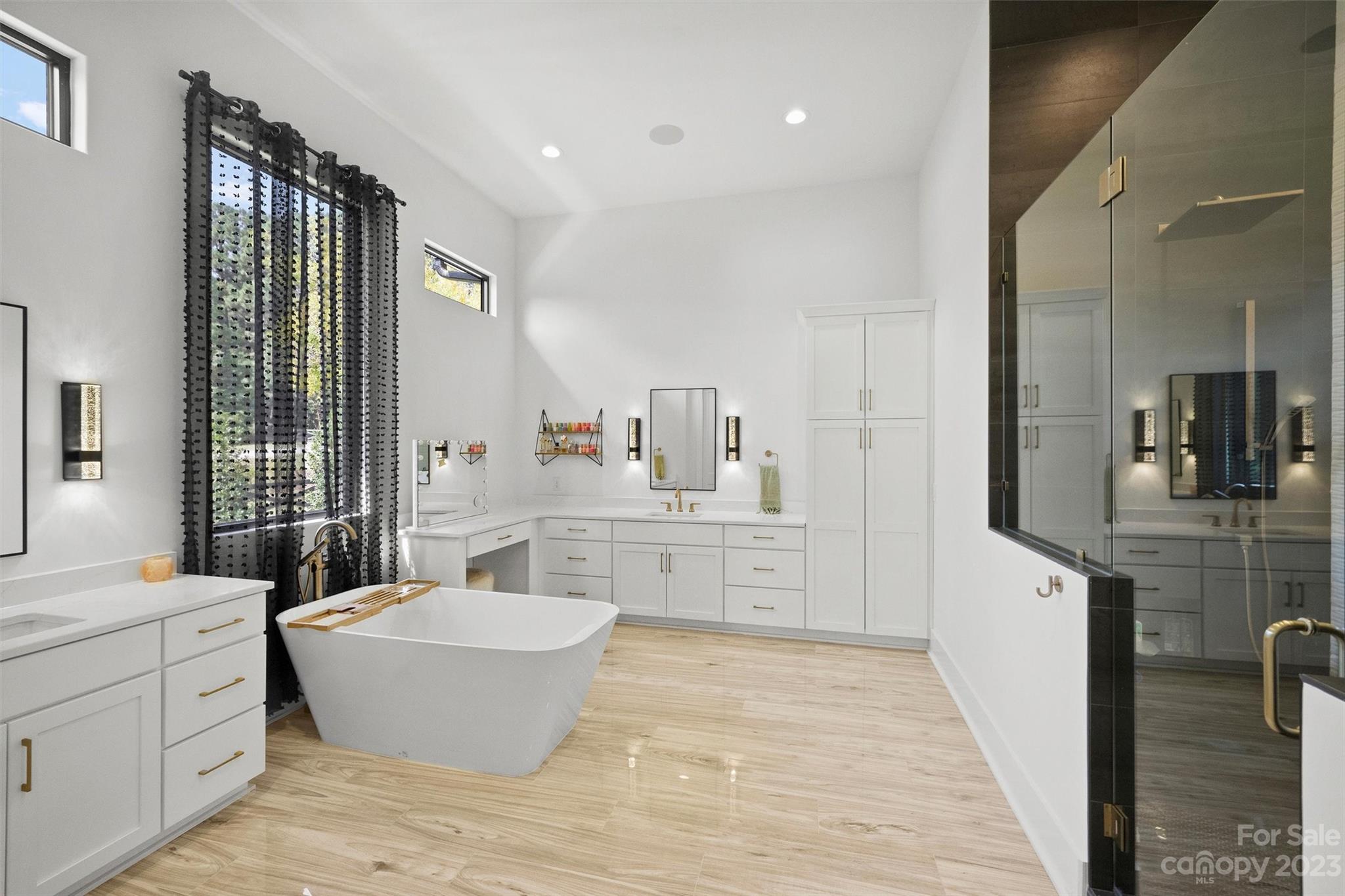 20108 Schooner Drive Cornelius, NC 28031 - Photo 19 of 46 a large room with kitchen island a sink wooden floor and glass door