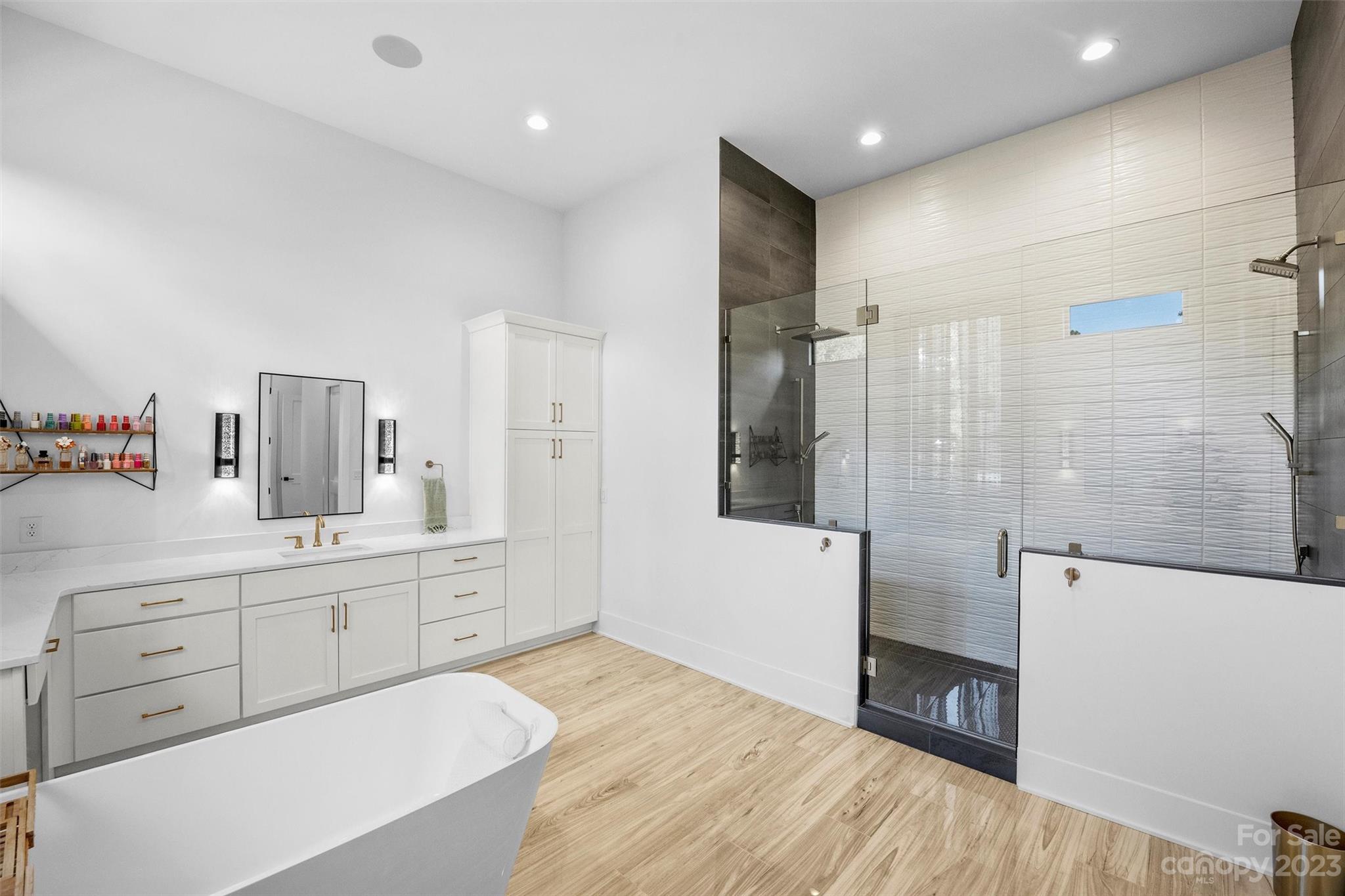 20108 Schooner Drive Cornelius, NC 28031 - Photo 20 of 46 a spacious bathroom with a shower a sink and a mirror