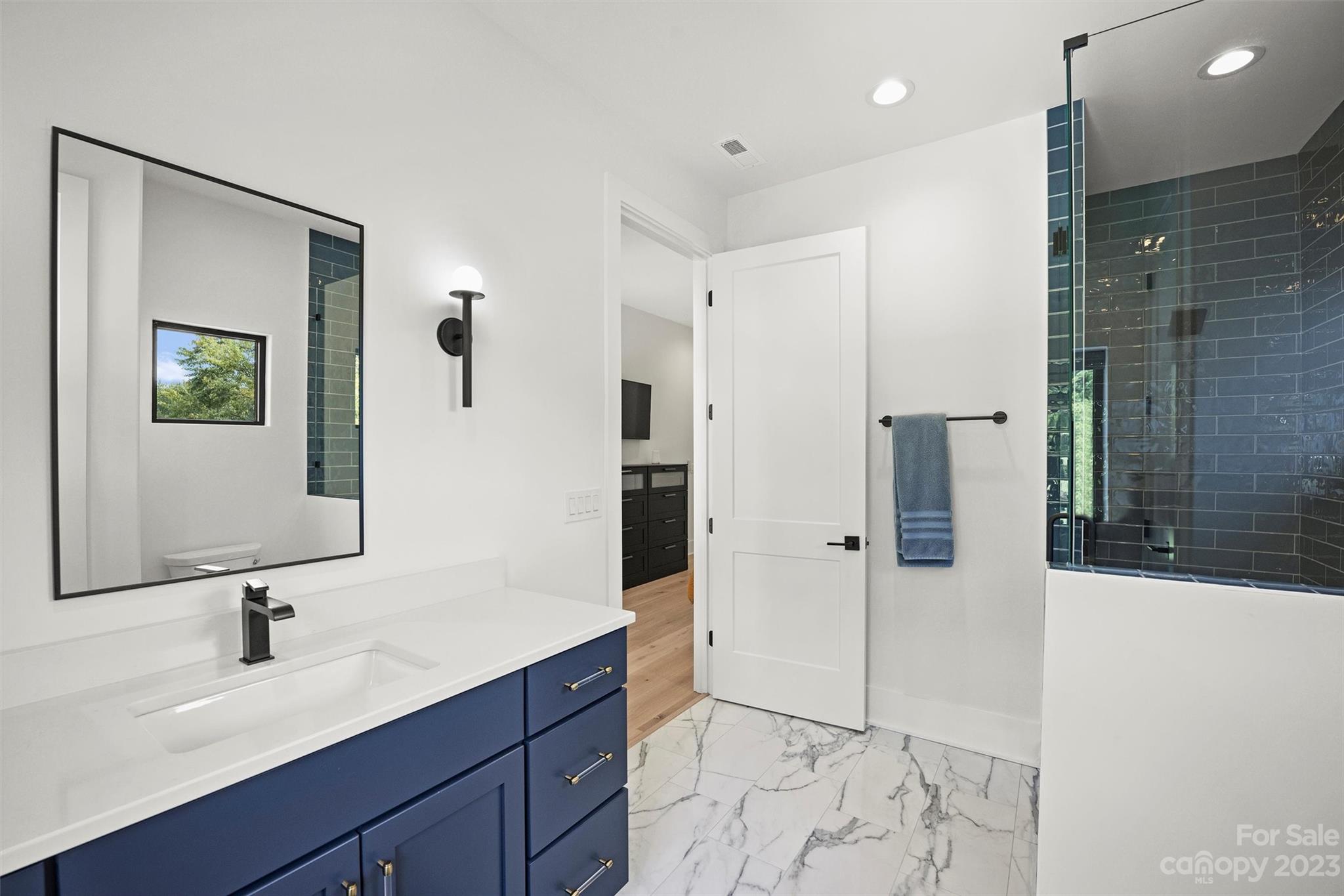 20108 Schooner Drive Cornelius, NC 28031 - Photo 28 of 46 a bathroom with a shower sink and mirror