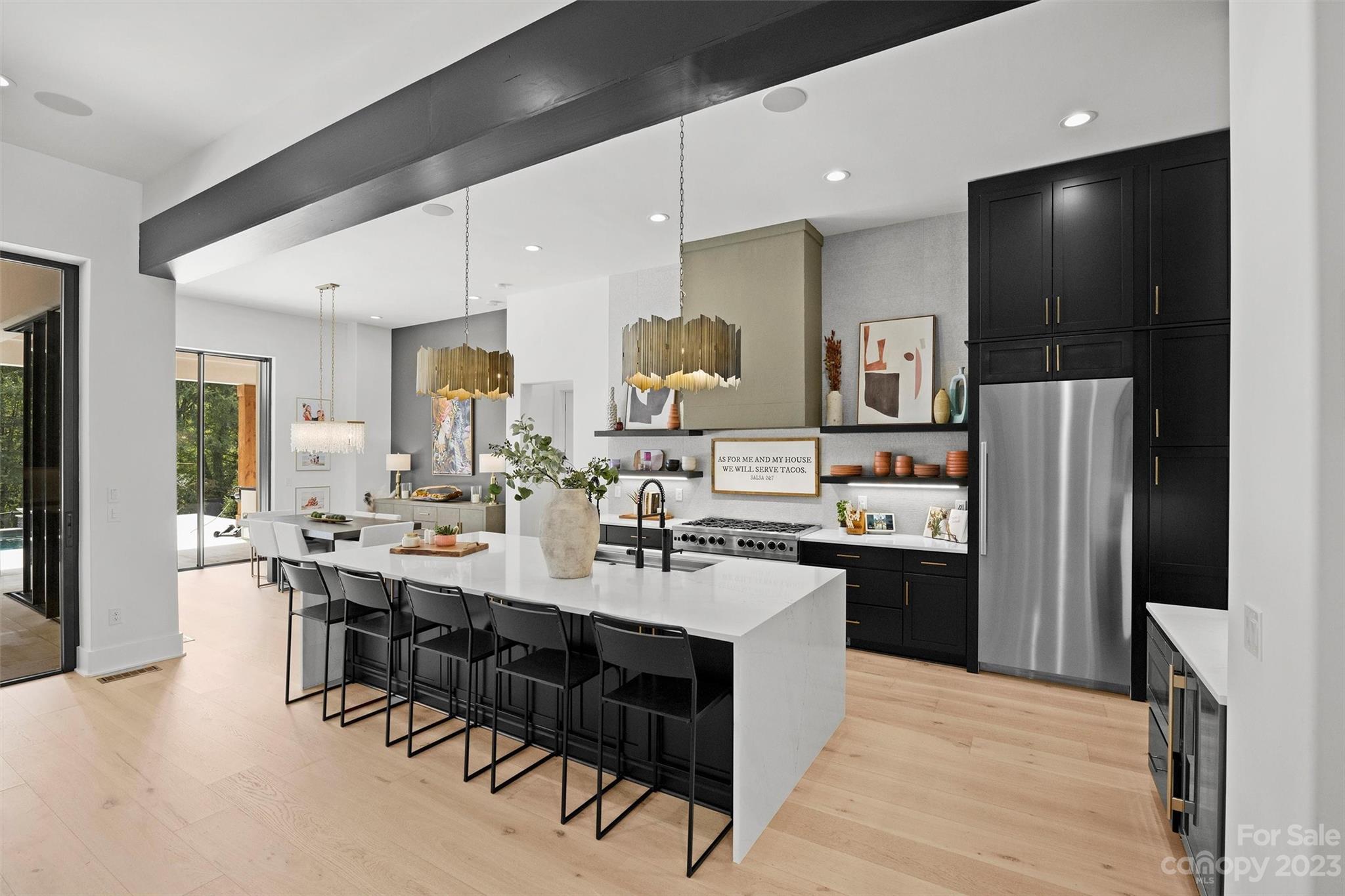 20108 Schooner Drive Cornelius, NC 28031 - Photo 3 of 46 a kitchen with stainless steel appliances kitchen island granite countertop a refrigerator and a stove top oven