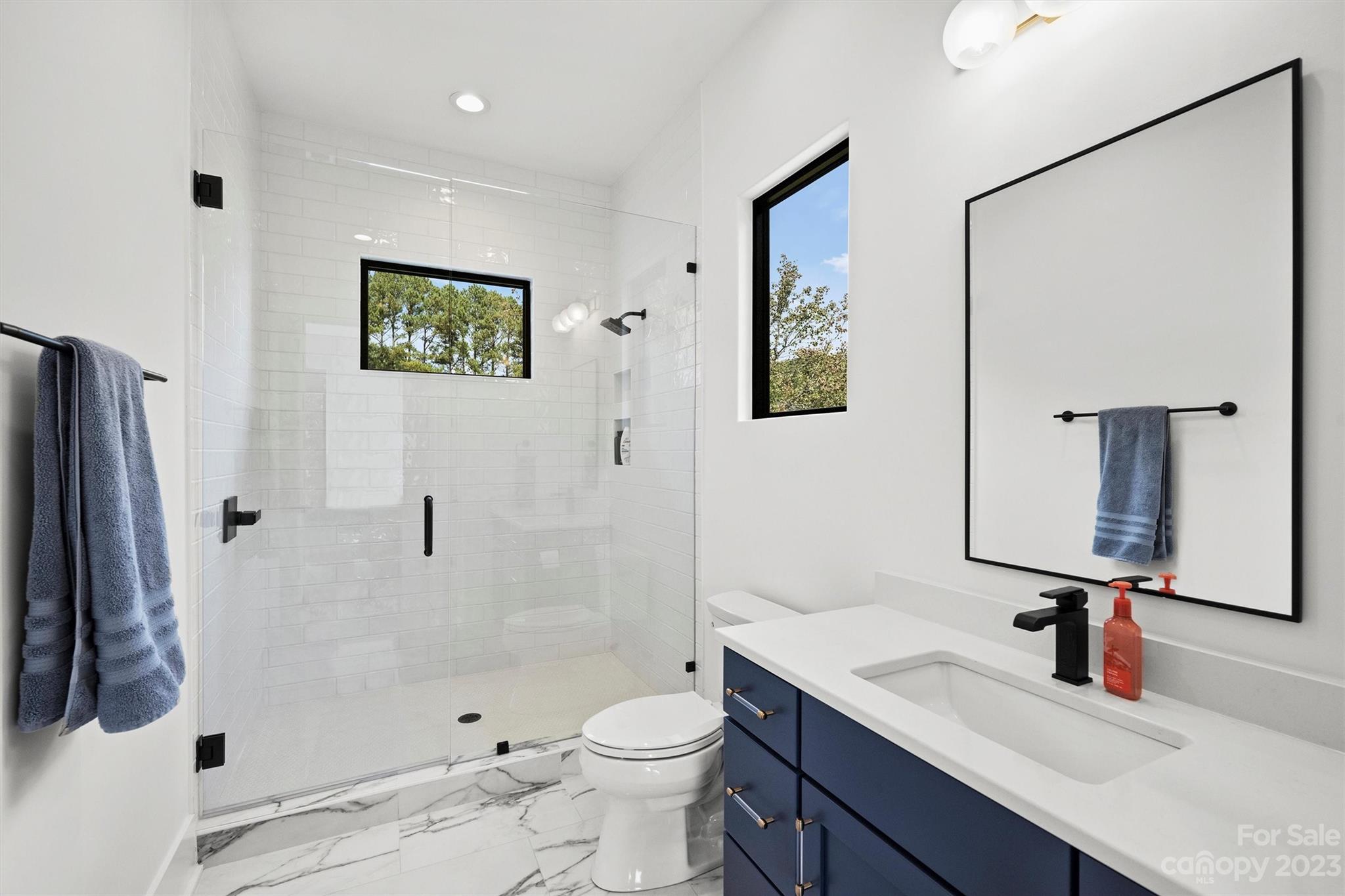 20108 Schooner Drive Cornelius, NC 28031 - Photo 31 of 46 a bathroom with a sink a toilet and shower