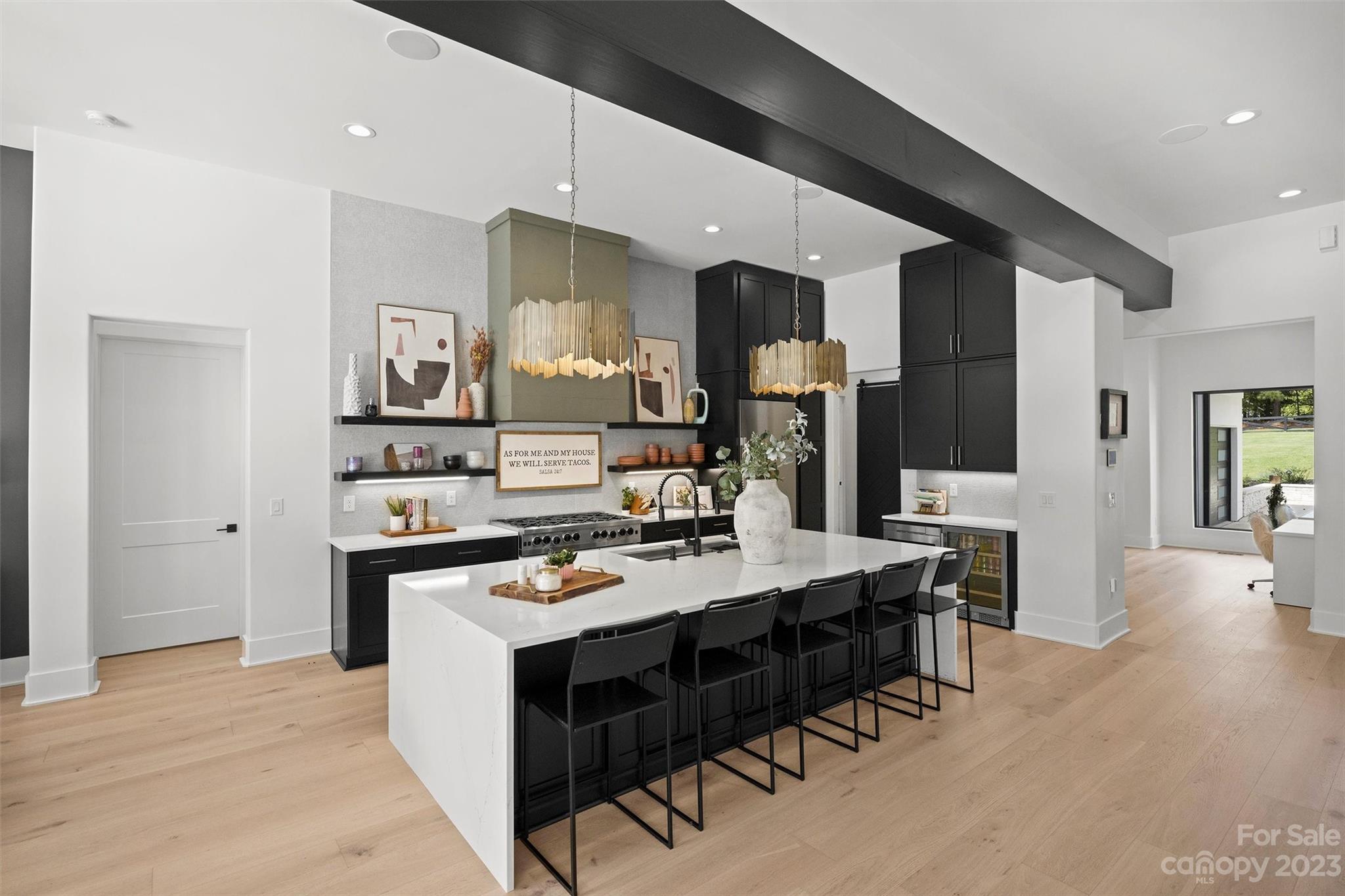 20108 Schooner Drive Cornelius, NC 28031 - Photo 5 of 46 a open kitchen with stainless steel appliances kitchen island granite countertop a stove refrigerator and cabinets