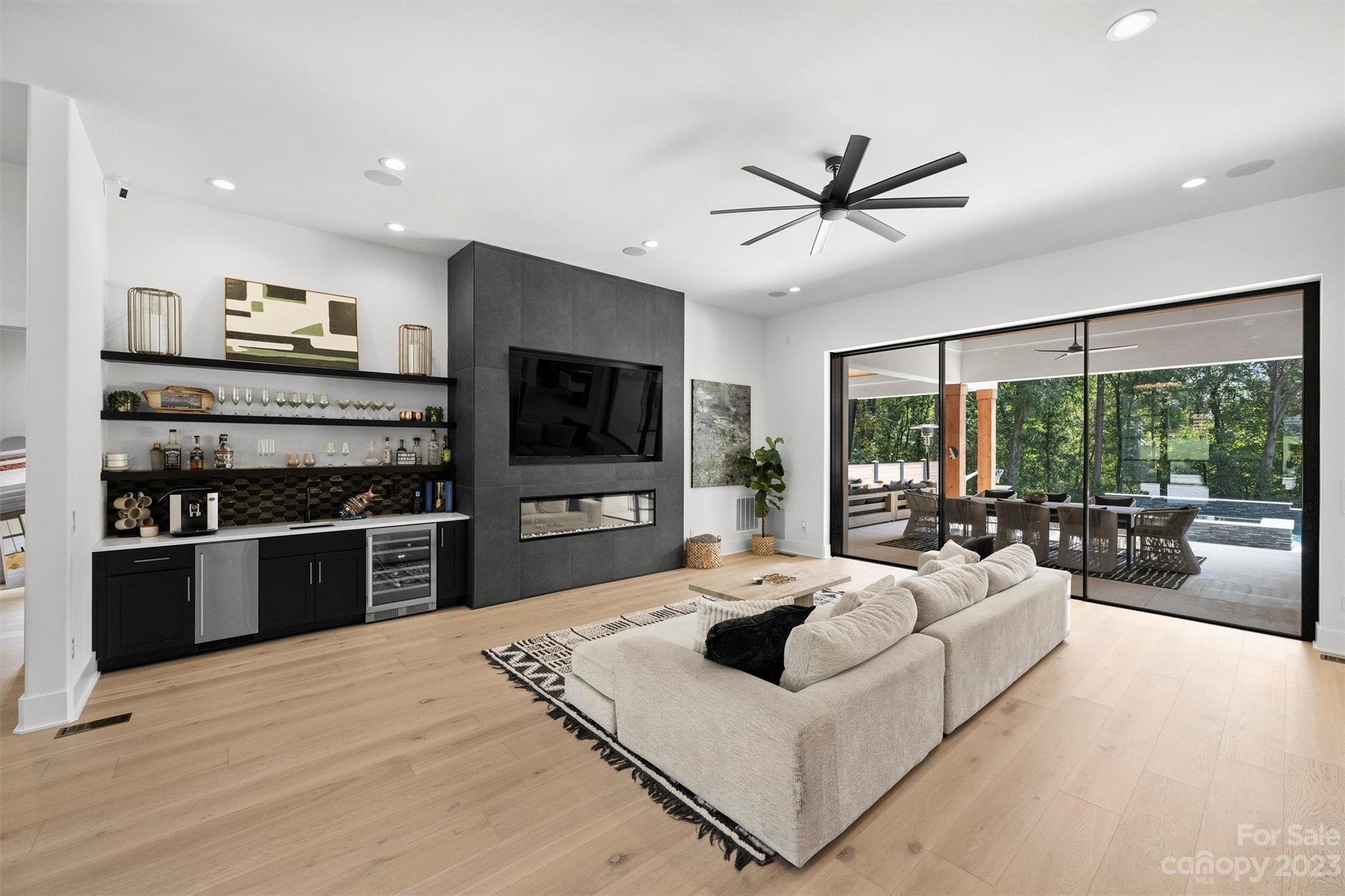 20108 Schooner Drive Cornelius, NC 28031 - Photo 7 of 46 a living room with furniture a flat screen tv and a floor to ceiling window