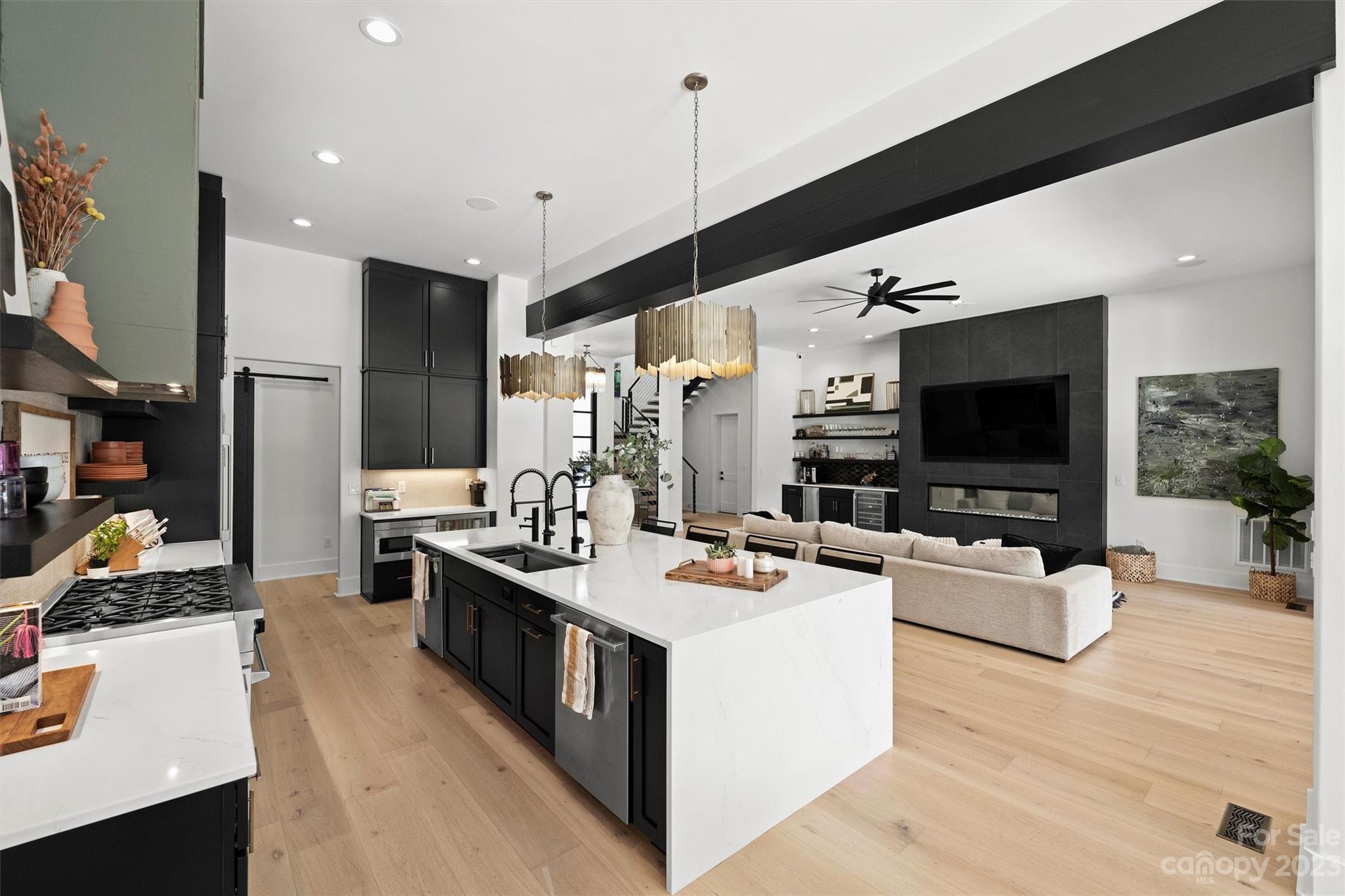 20108 Schooner Drive Cornelius, NC 28031 - Photo 8 of 46 a living room with stainless steel appliances kitchen island furniture a flat screen tv and a chandelier
