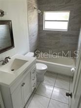 702 Michigan Court, Unit 4 St. Cloud, FL 34769 - Photo 7 of 9 a bathroom with a sink toilet and mirror