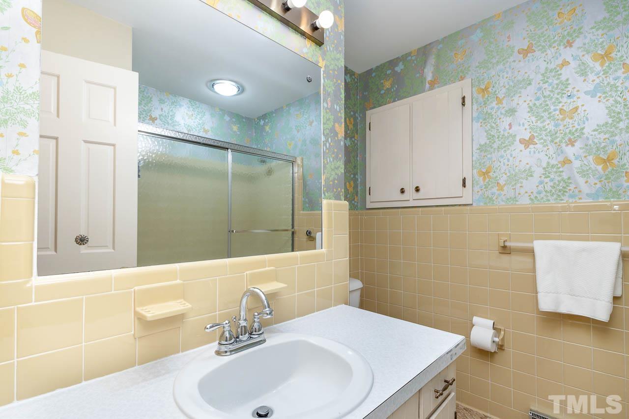 200 Ridge Road Northwest Wilson, NC 27896 - Photo 13 of 25 a bathroom with a sink a toilet and shower