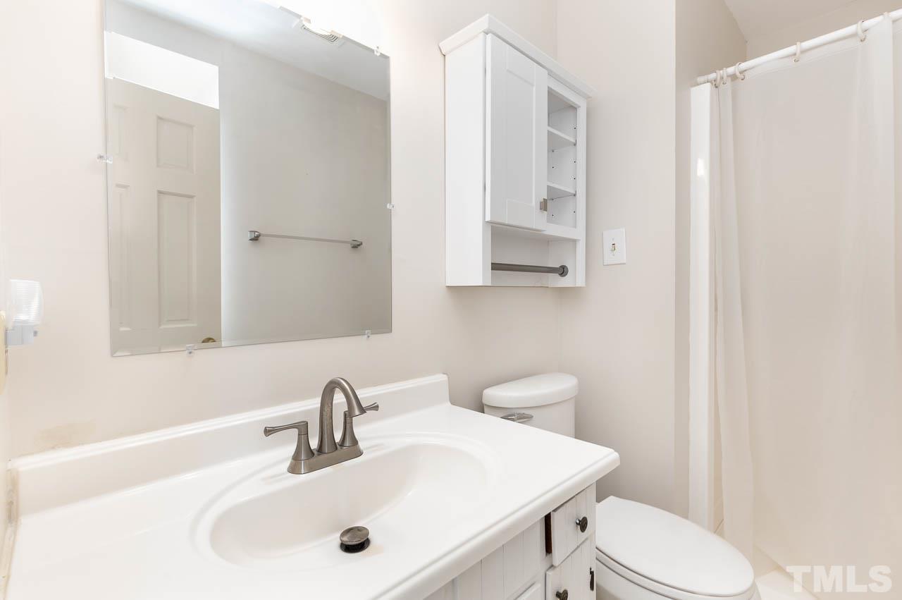 200 Ridge Road Northwest Wilson, NC 27896 - Photo 18 of 25 a bathroom with a sink a toilet and mirror