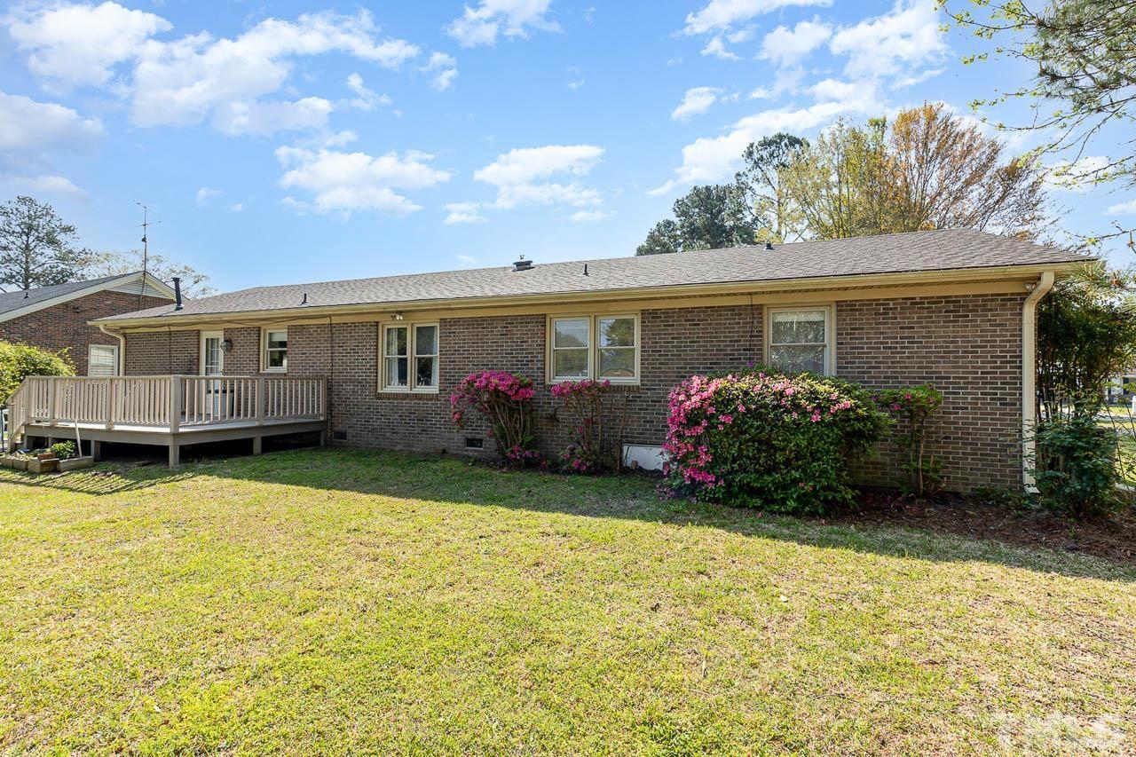 200 Ridge Road Northwest Wilson, NC 27896 - Photo 20 of 25 a view of a house with swimming pool and a garden