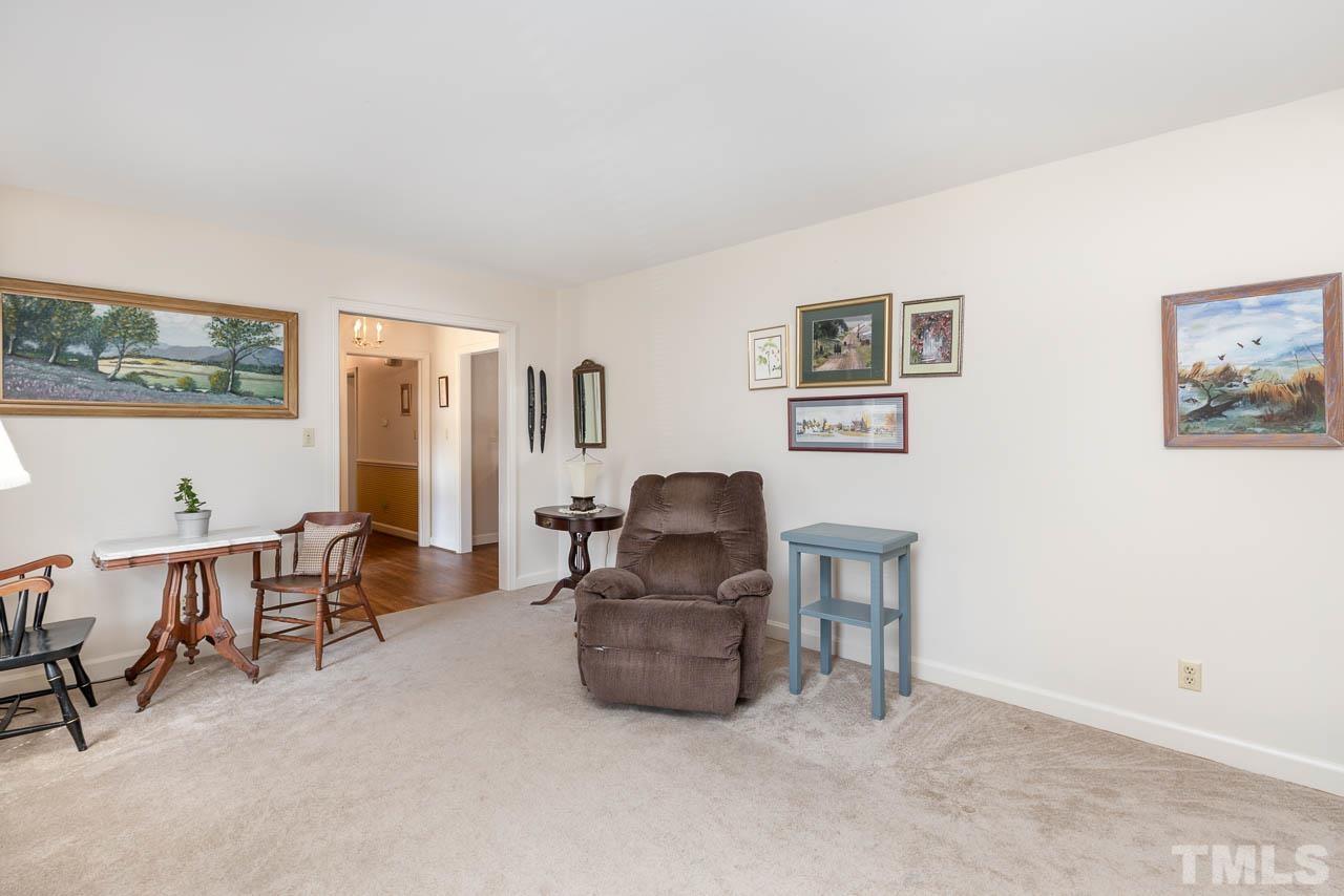 200 Ridge Road Northwest Wilson, NC 27896 - Photo 5 of 25 a living room with furniture and a dining table with rug