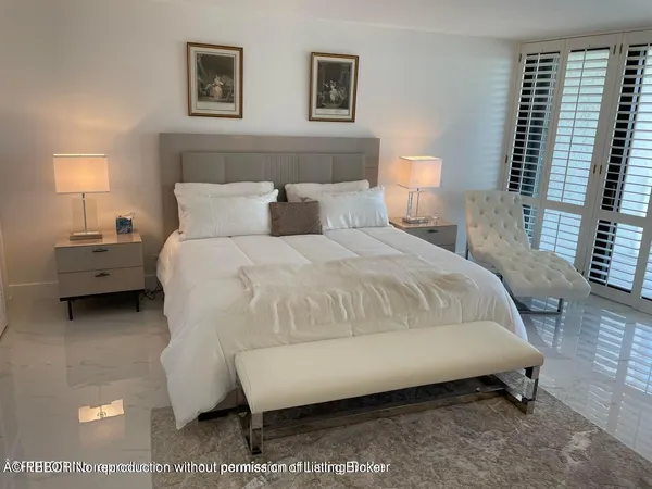 a bedroom with bed and a night stand