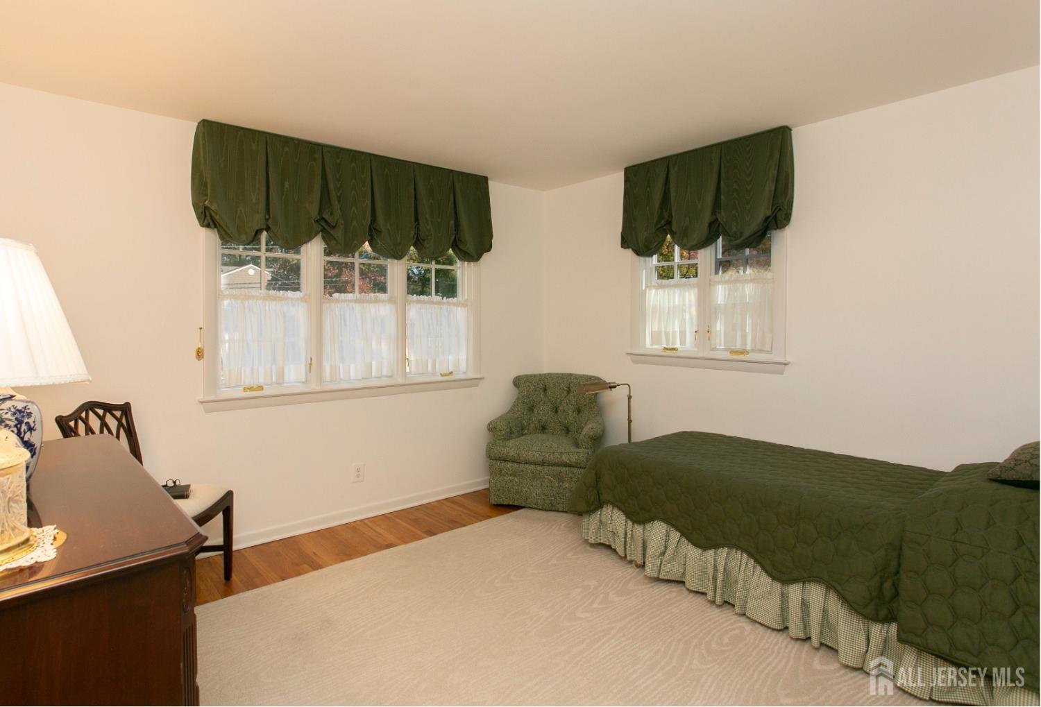 24 Huntington Road Edison, NJ 08820 - Photo 27 of 37 a bedroom with furniture and a flat screen tv