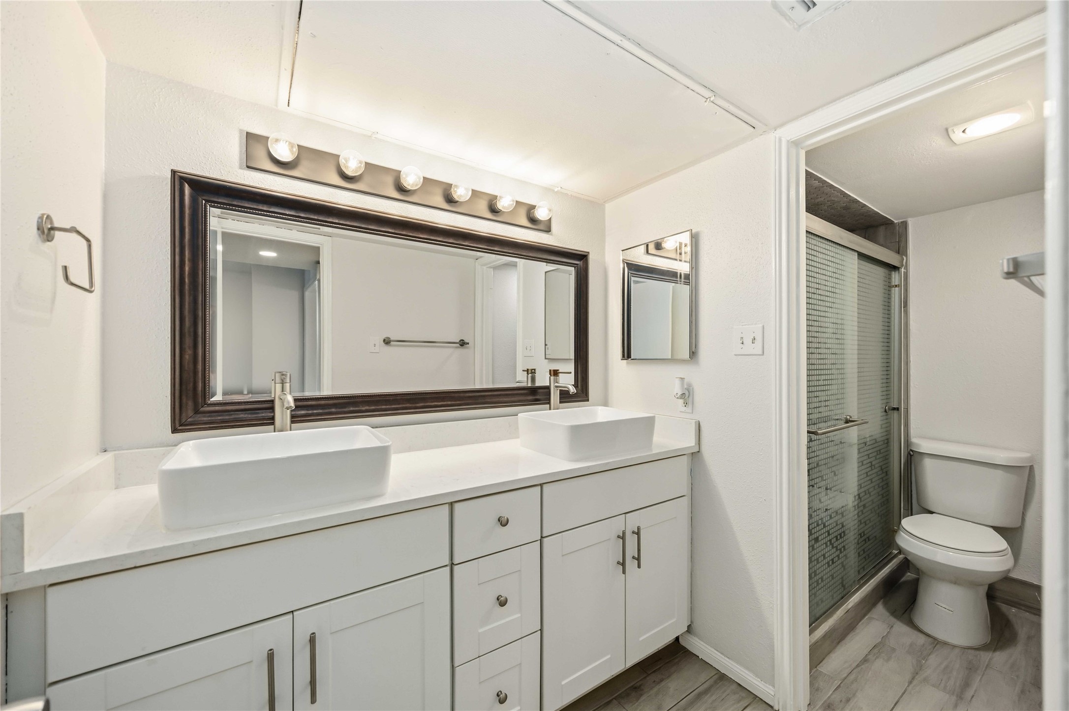 2100 Tanglewilde Street, Unit 531 Houston, TX 77063 - Photo 12 of 25 a bathroom with a toilet sink and mirror