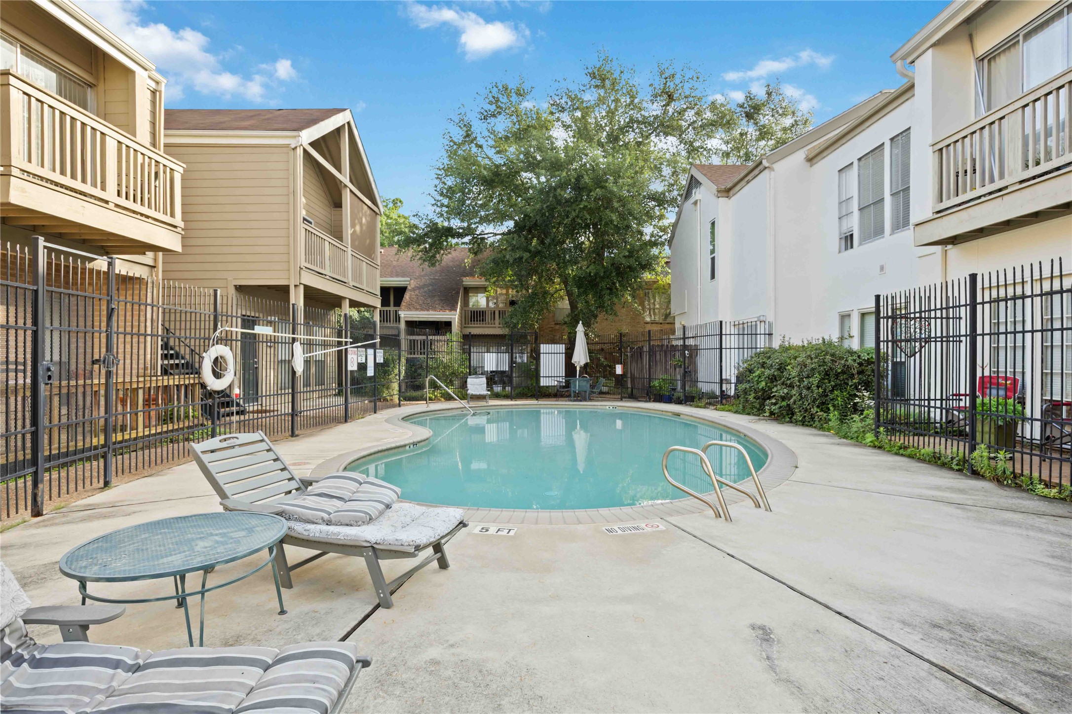 2100 Tanglewilde Street, Unit 531 Houston, TX 77063 - Photo 17 of 25 a swimming pool with outdoor seating and yard