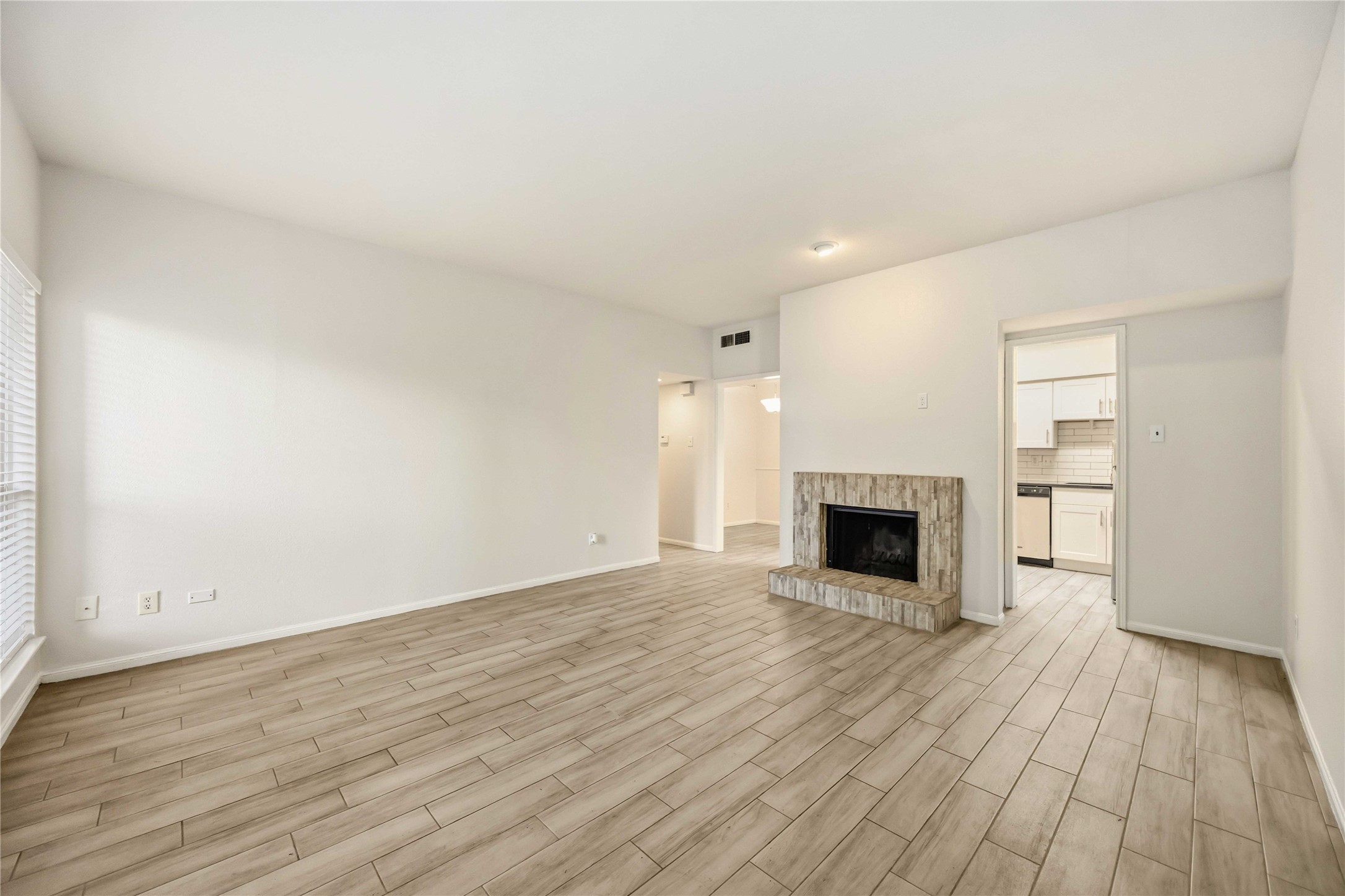 2100 Tanglewilde Street, Unit 531 Houston, TX 77063 - Photo 2 of 25 a view of a livingroom with wooden floor and a fireplace
