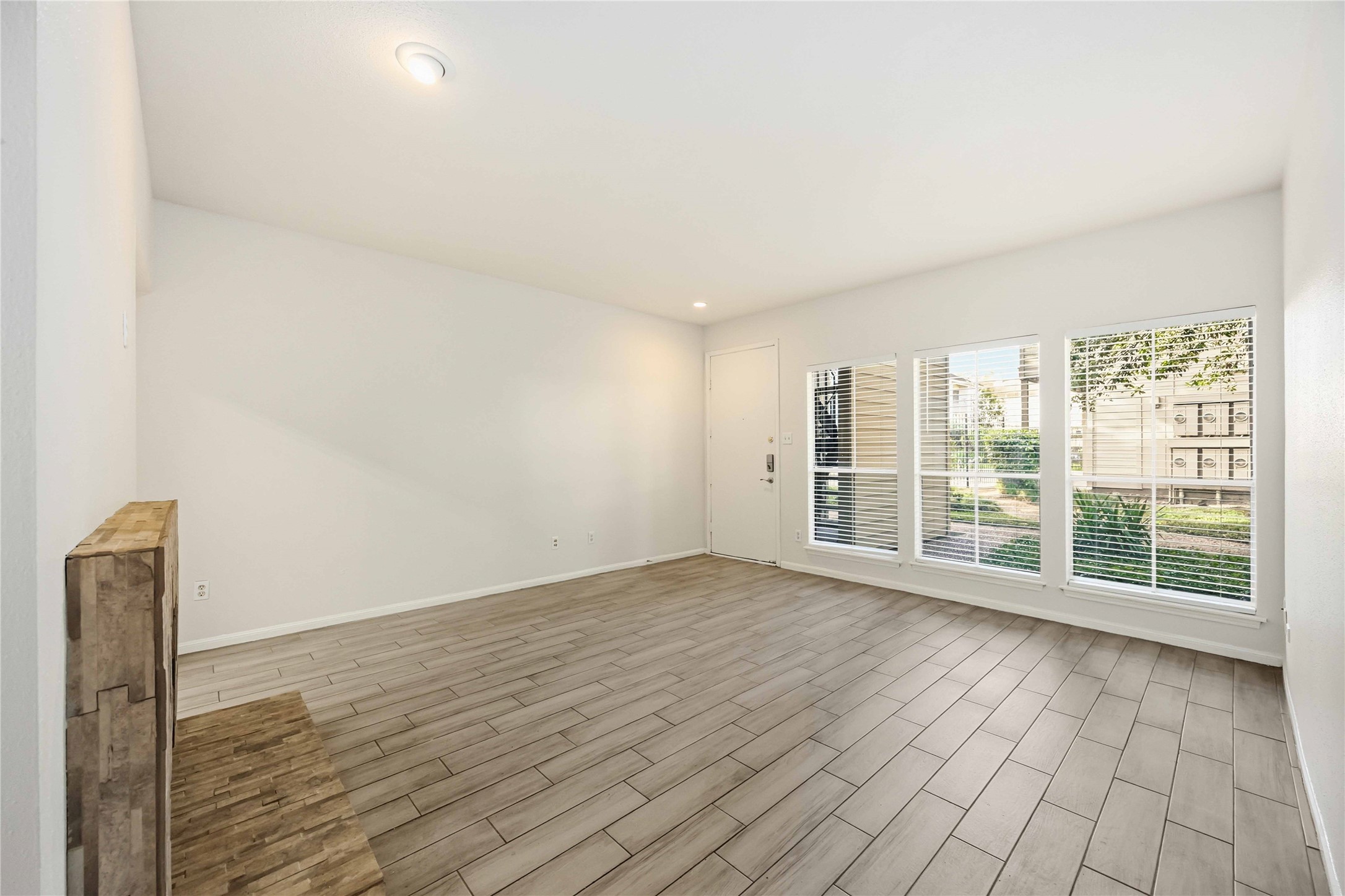 2100 Tanglewilde Street, Unit 531 Houston, TX 77063 - Photo 5 of 25 a view of an empty room with wooden floor and a window