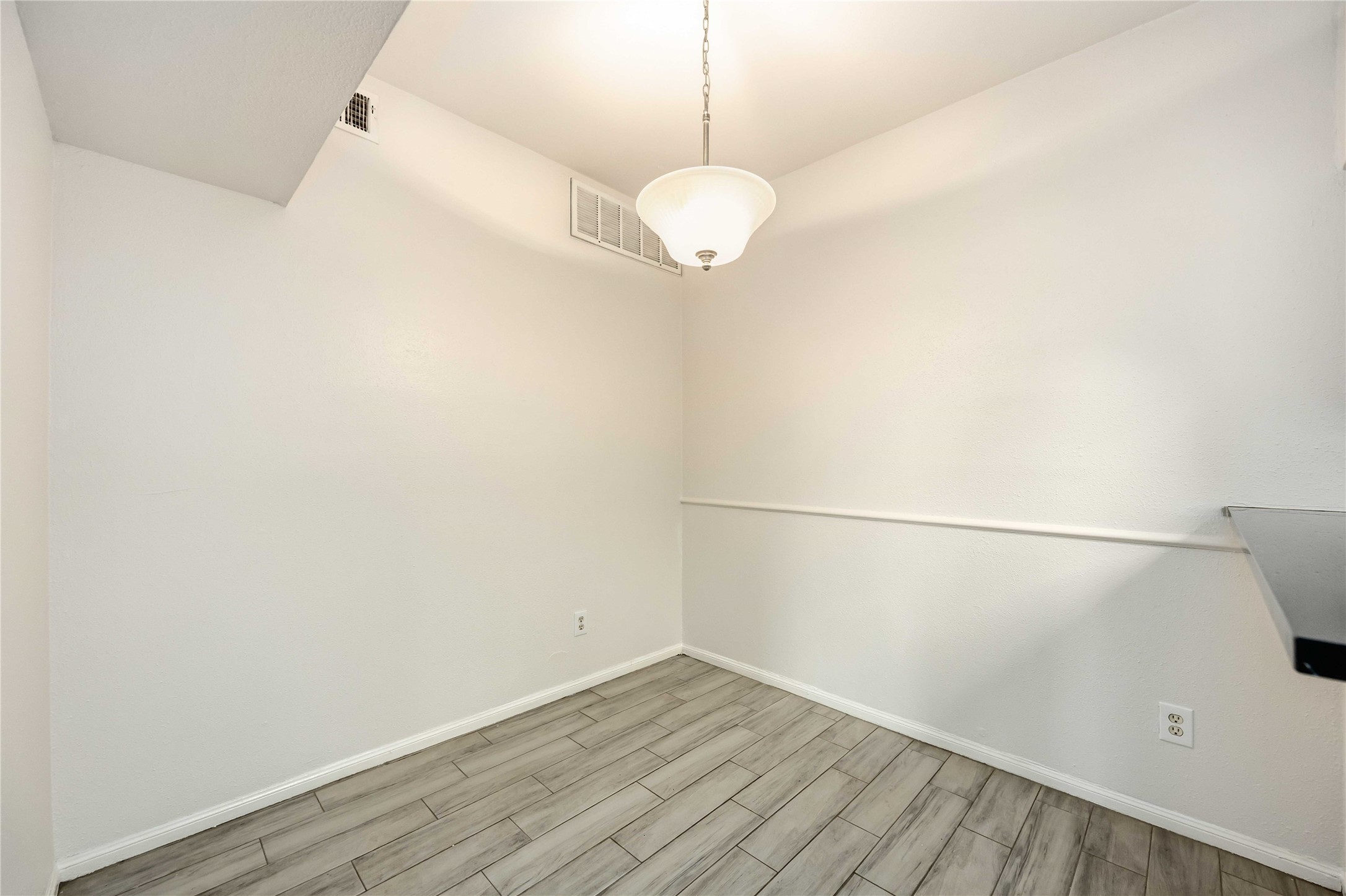 2100 Tanglewilde Street, Unit 531 Houston, TX 77063 - Photo 9 of 25 a view of a room with wooden floor and white walls
