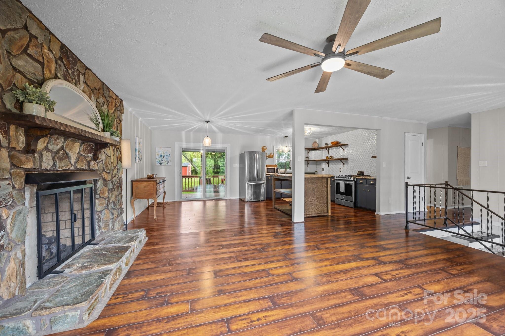 917 West Chapel Road Asheville, NC 28803 - Photo 11 of 28 a view of dining room with wooden floor and a fireplace