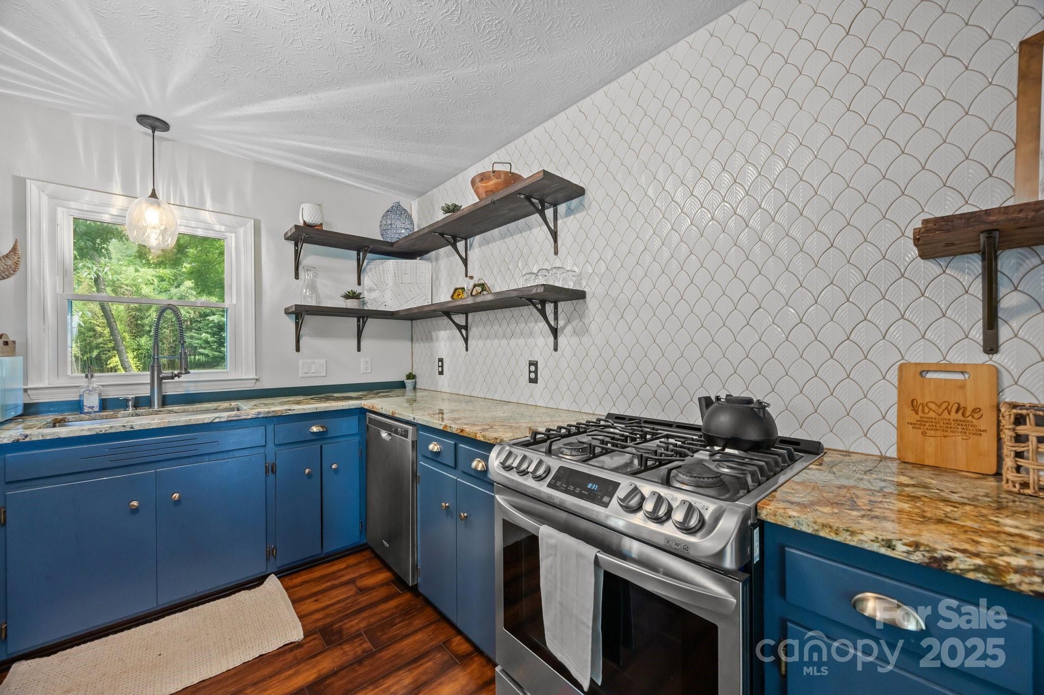 917 West Chapel Road Asheville, NC 28803 - Photo 12 of 28 a kitchen with stainless steel appliances granite countertop a stove and a sink