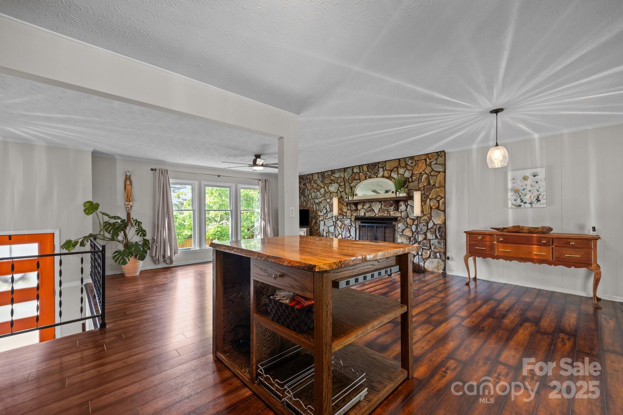 917 West Chapel Road Asheville, NC 28803 - Photo 15 of 28 a room with stainless steel appliances kitchen island granite countertop furniture and a wooden floors