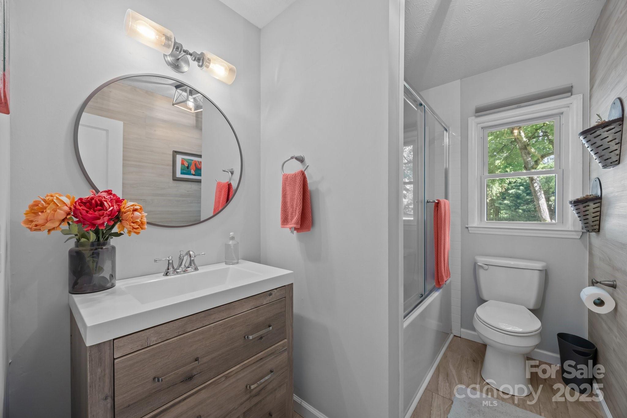 917 West Chapel Road Asheville, NC 28803 - Photo 16 of 28 a bathroom with a sink mirror and toilet