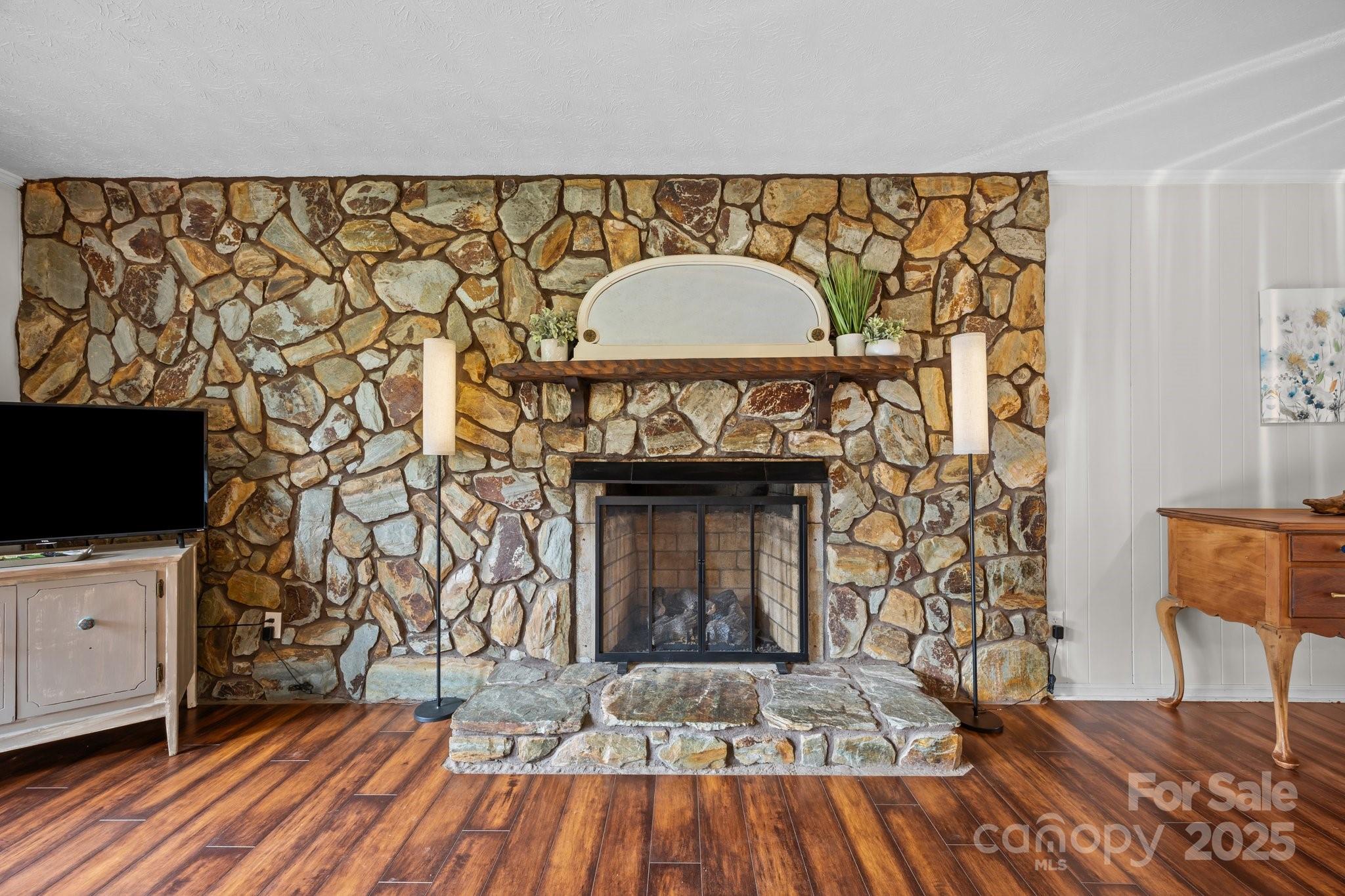 917 West Chapel Road Asheville, NC 28803 - Photo 3 of 28 a living room with a fireplace and a flat screen tv