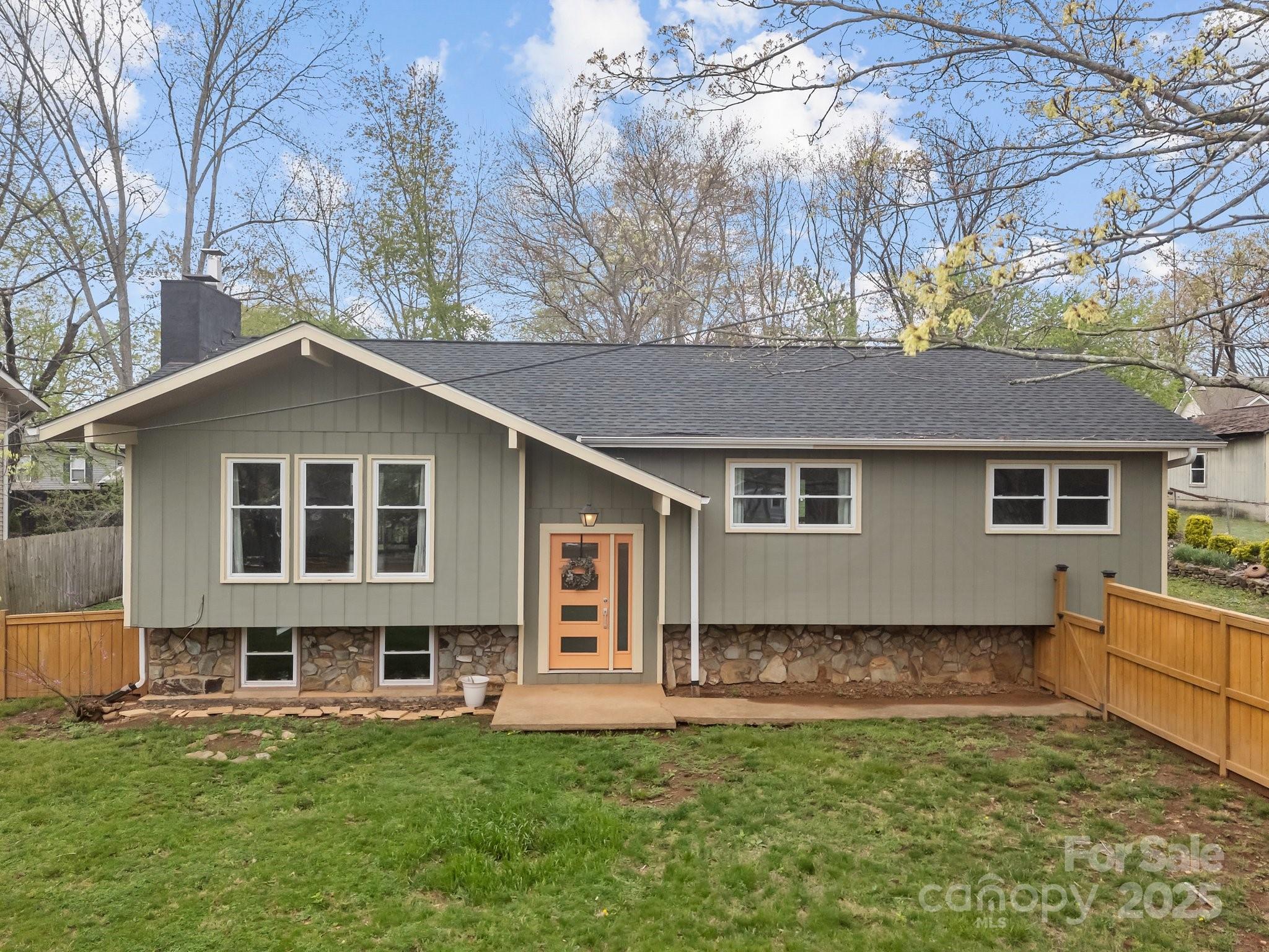 917 West Chapel Road Asheville, NC 28803 - Photo 8 of 28 a front view of house with yard and trees in the background