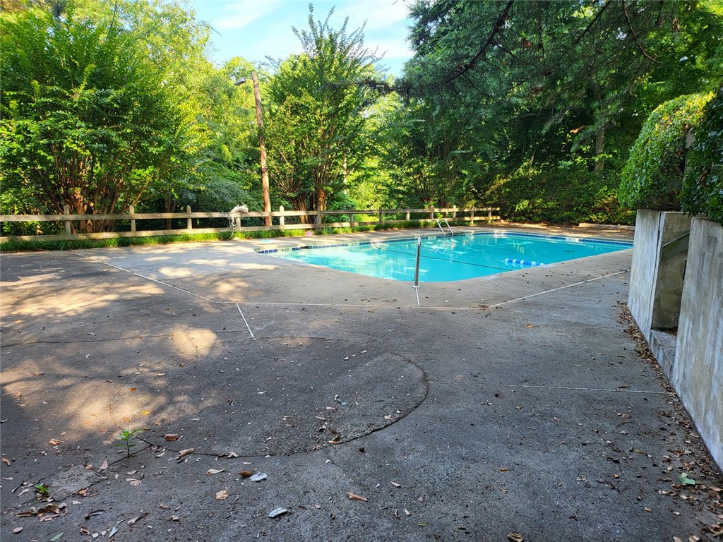 150 Ligon Street, Unit 1001 Clemson, SC 29631 - Photo 29 of 29 A private in-ground pool surrounded by dense greenery offers a tranquil retreat.