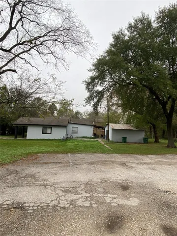 a view of a backyard with large trees