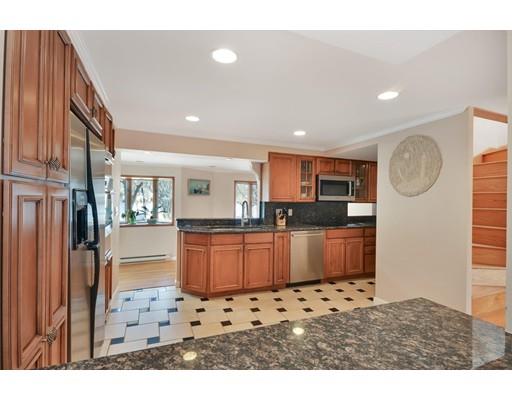 25 Truman Road Newton, MA 02459 - Photo 7 of 19 a kitchen with stainless steel appliances kitchen island granite countertop a refrigerator and cabinets