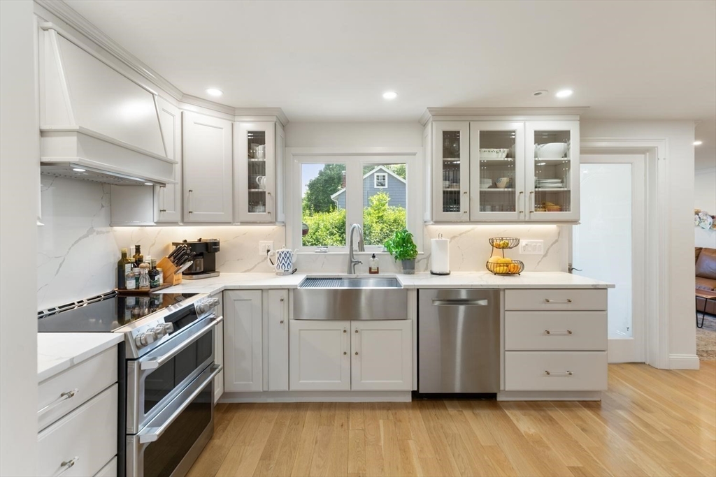 155 Adams Avenue Newton, MA 02465 - Photo 11 of 37 a kitchen with stainless steel appliances a stove top oven and sink