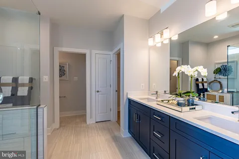 a bathroom with a double vanity sink mirror and double