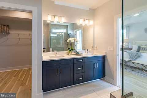 a bathroom with a double vanity sink and a mirror