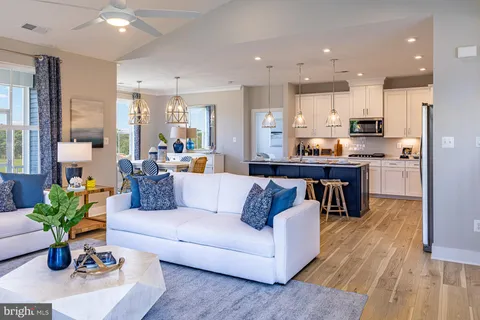 a living room with kitchen island furniture and a wooden floor
