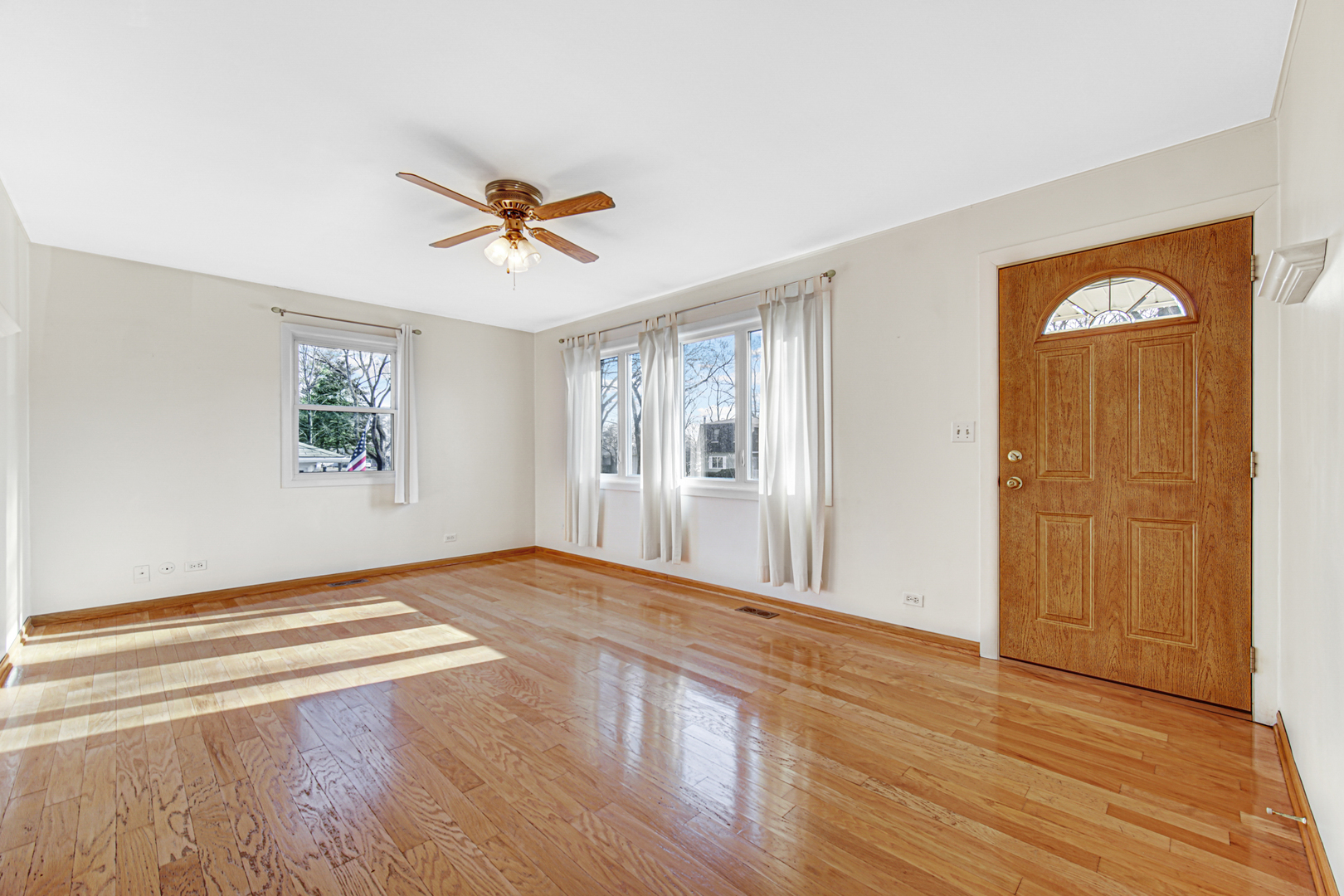 2109 Robin Lane Rolling Meadows, IL 60008 - Photo 6 of 21 a view of a livingroom with a window and wooden floor