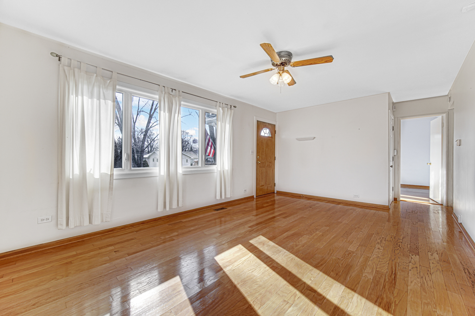 2109 Robin Lane Rolling Meadows, IL 60008 - Photo 7 of 21 a view of an empty room with window and wooden floor