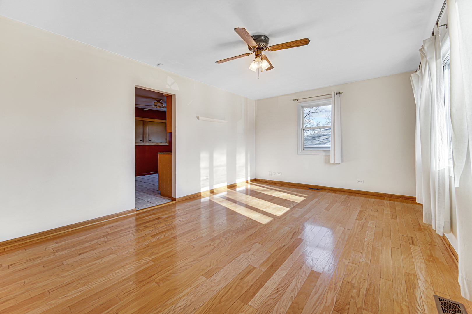 2109 Robin Lane Rolling Meadows, IL 60008 - Photo 8 of 21 wooden floor in an empty room with a window