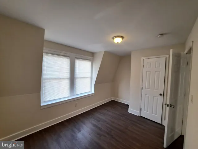 a bathroom with a sink and mirror with bathtub