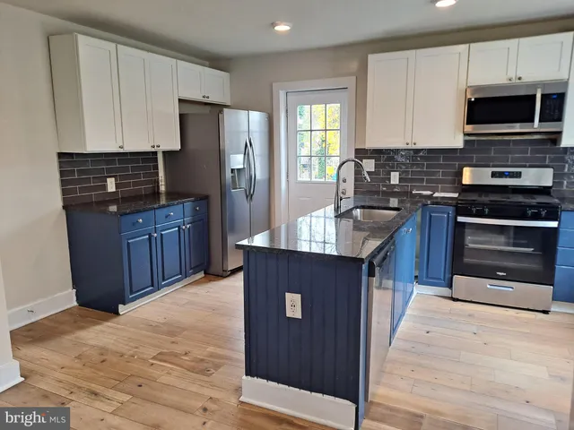 a kitchen with a refrigerator and cabinets