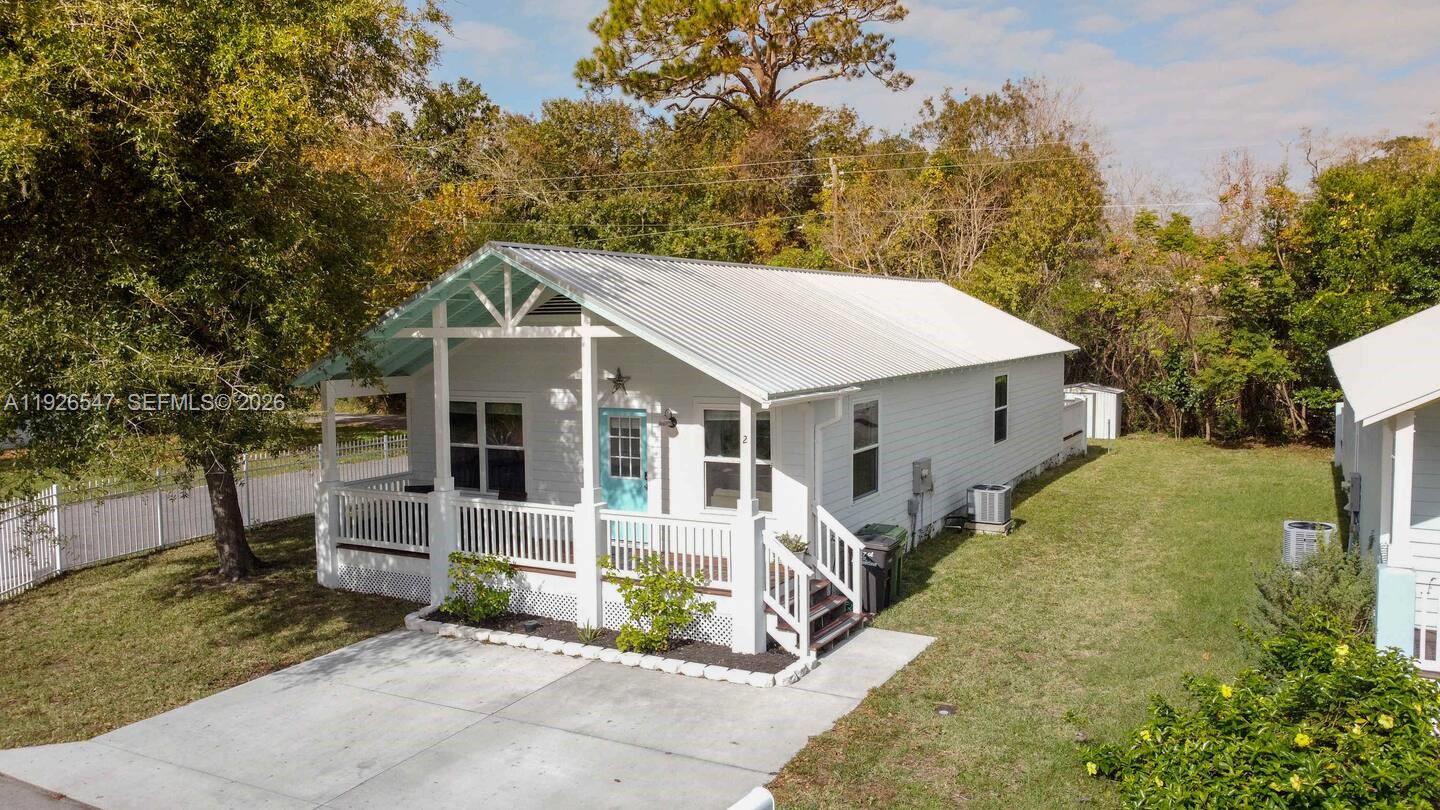 2 Poinciana Cove Road St. Augustine, FL 32084 - Photo 3 of 43 view of a house with a yard and potted plants