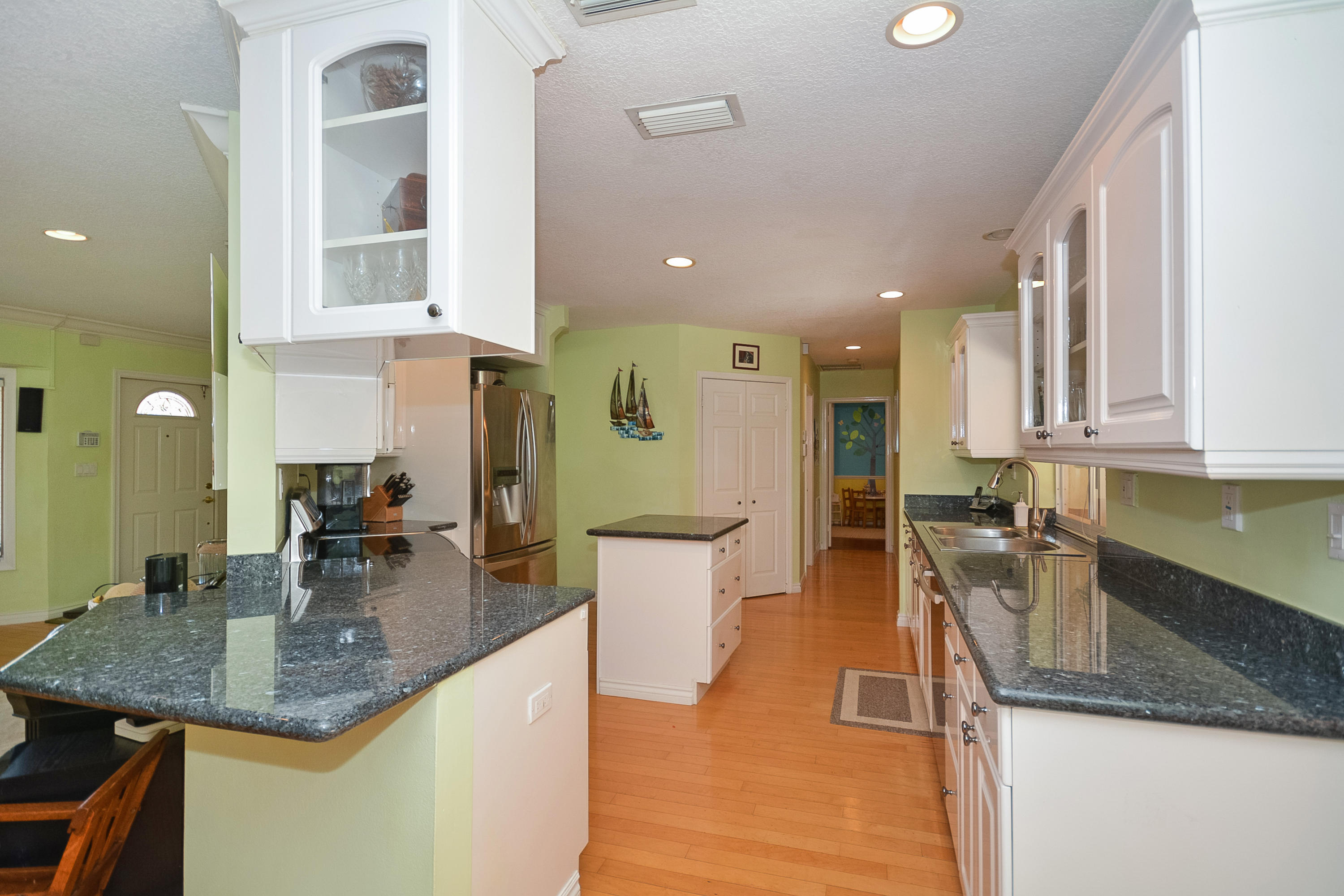 856 Appleby Street Boca Raton, FL 33487 - Photo 8 of 30 a kitchen with stainless steel appliances granite countertop a sink refrigerator and cabinets