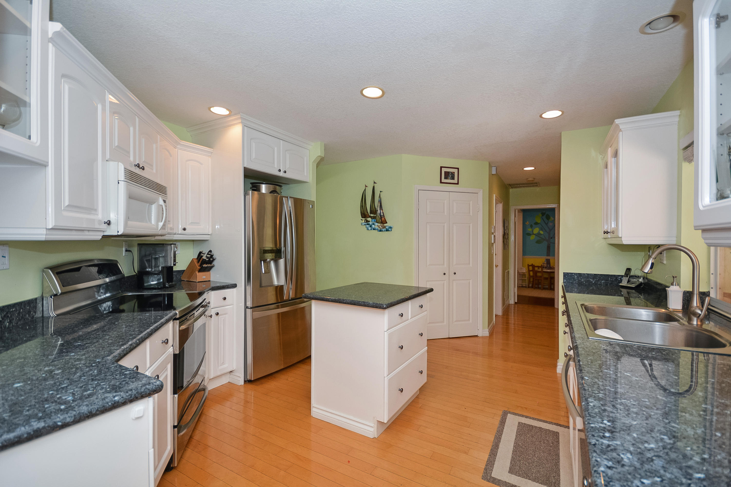 856 Appleby Street Boca Raton, FL 33487 - Photo 9 of 30 a kitchen with stainless steel appliances granite countertop a sink stove and refrigerator
