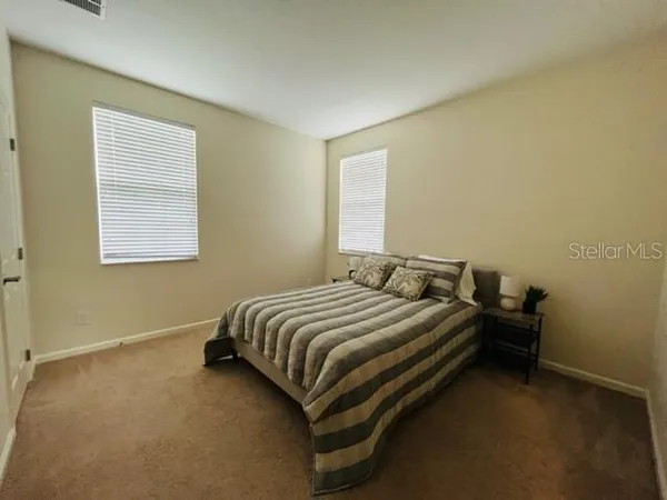 a bedroom with a bed and window