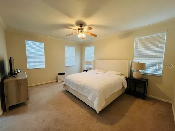 a bedroom with a bed and a chandelier