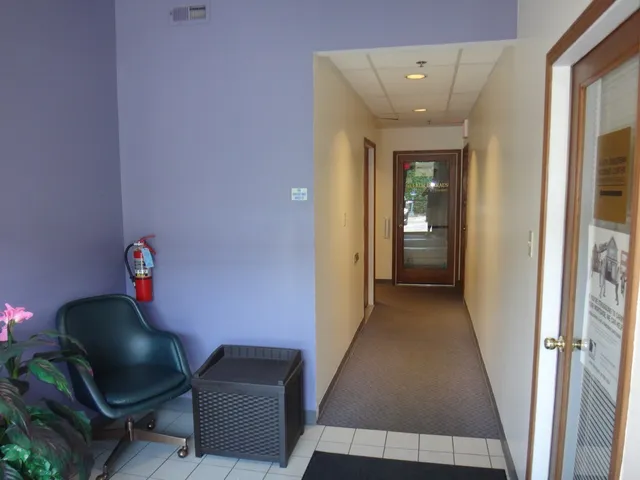 a living room with furniture and a lamp