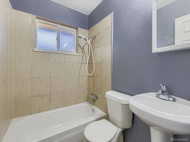a view of a room with wooden floor and bathroom