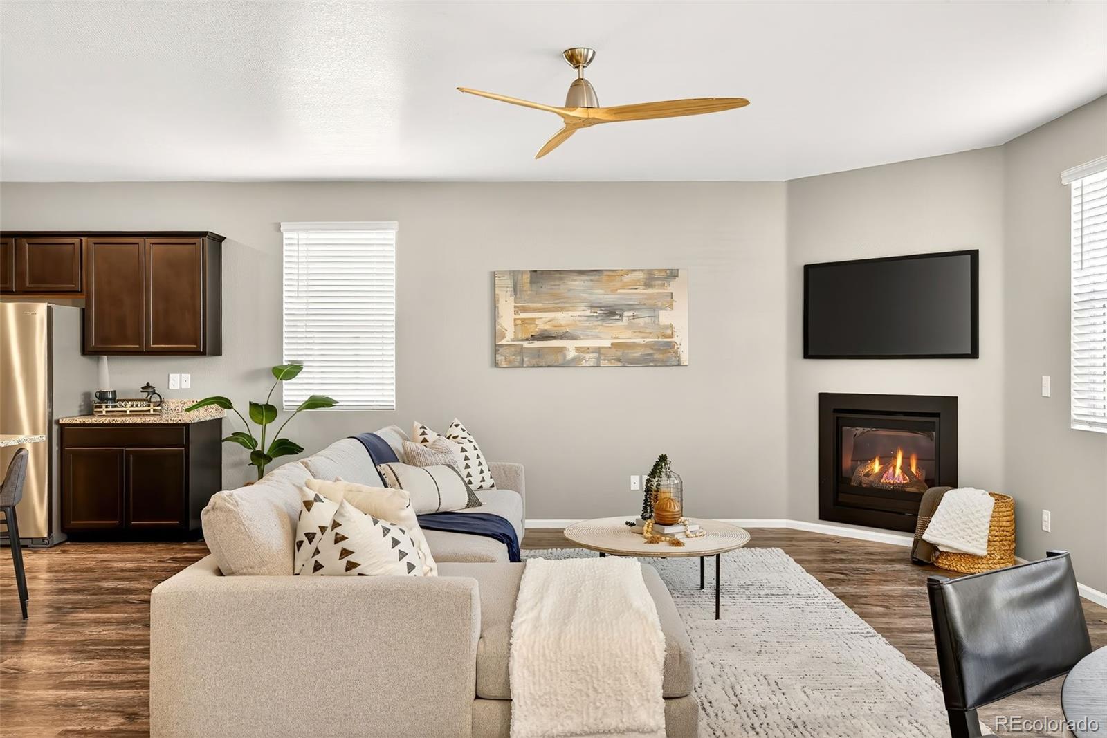 22603 East Radcliff Drive Aurora, CO 80015 - Photo 11 of 42 a living room with furniture a flat screen tv and a fireplace